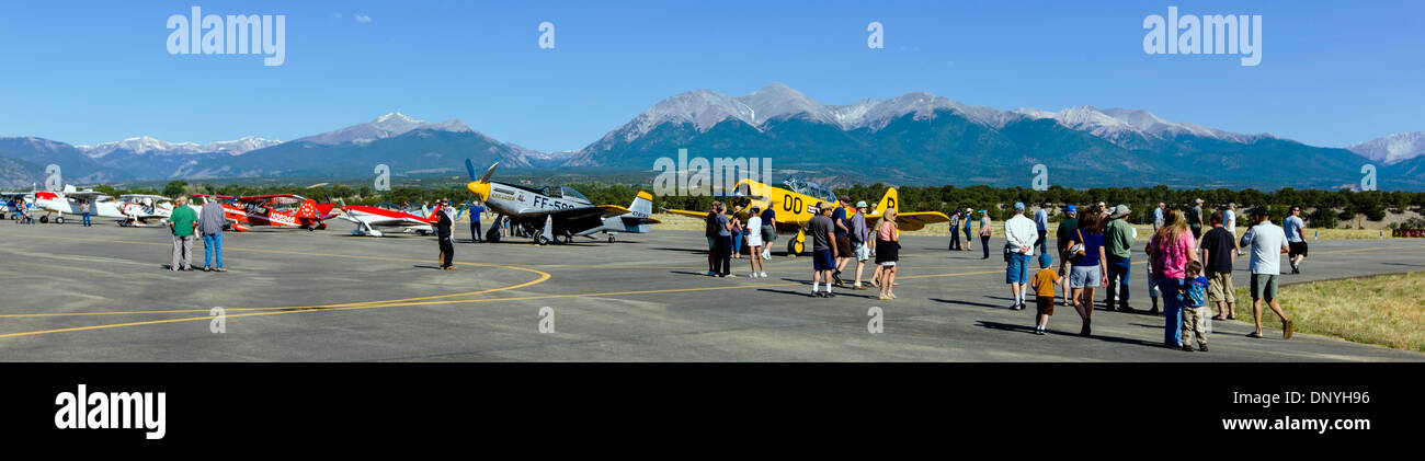 Panorama view of visitors inspecting antique and modern airplanes at the annual Salida, Colorado,  ArtWalk Fly-In event Stock Photo