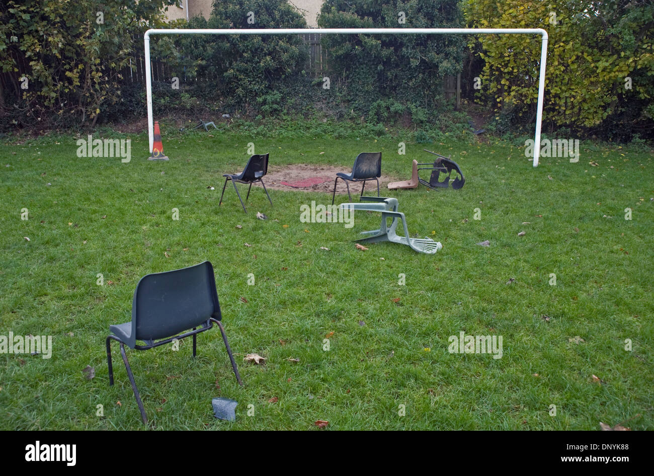 Abandoned plastic chairs on football pitch, Glynn, Northern Ireland. Stock Photo