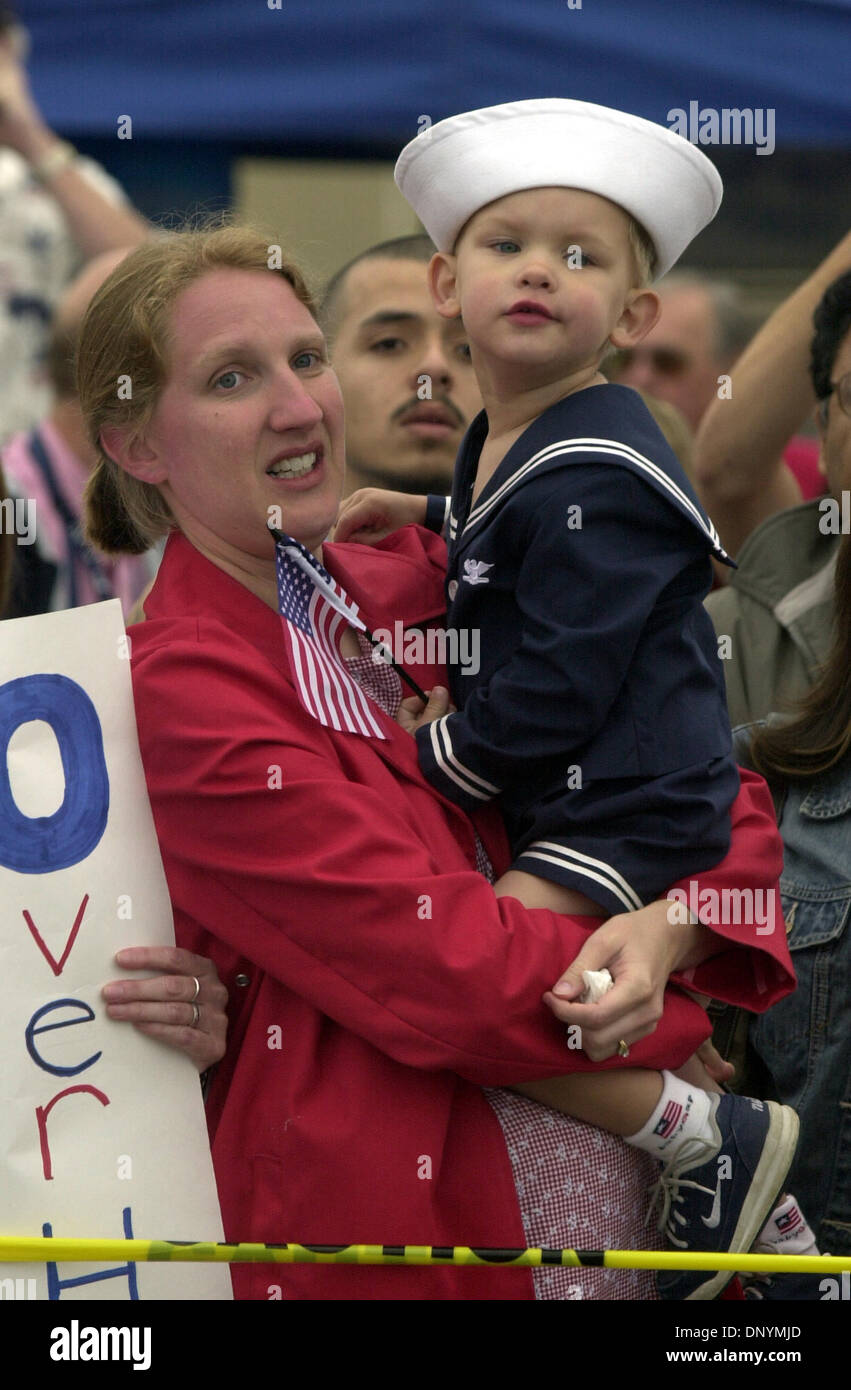 (Published on SignOn: 06/02/2003) Sarah Tompkins of Chicago, Illinois, holds her son, James, 2-1/2, as they wait for their cousin, Operations Specialist Calvin Olsen, as the USS Bunker Hill, a guided missile cruiser, arrives in San Diego. The Constellation Carrier Strike Group including the USS Constellation, the USS Bunker Hill, the USS Valley Forge, the USS Milius, and USS Thach  Stock Photo