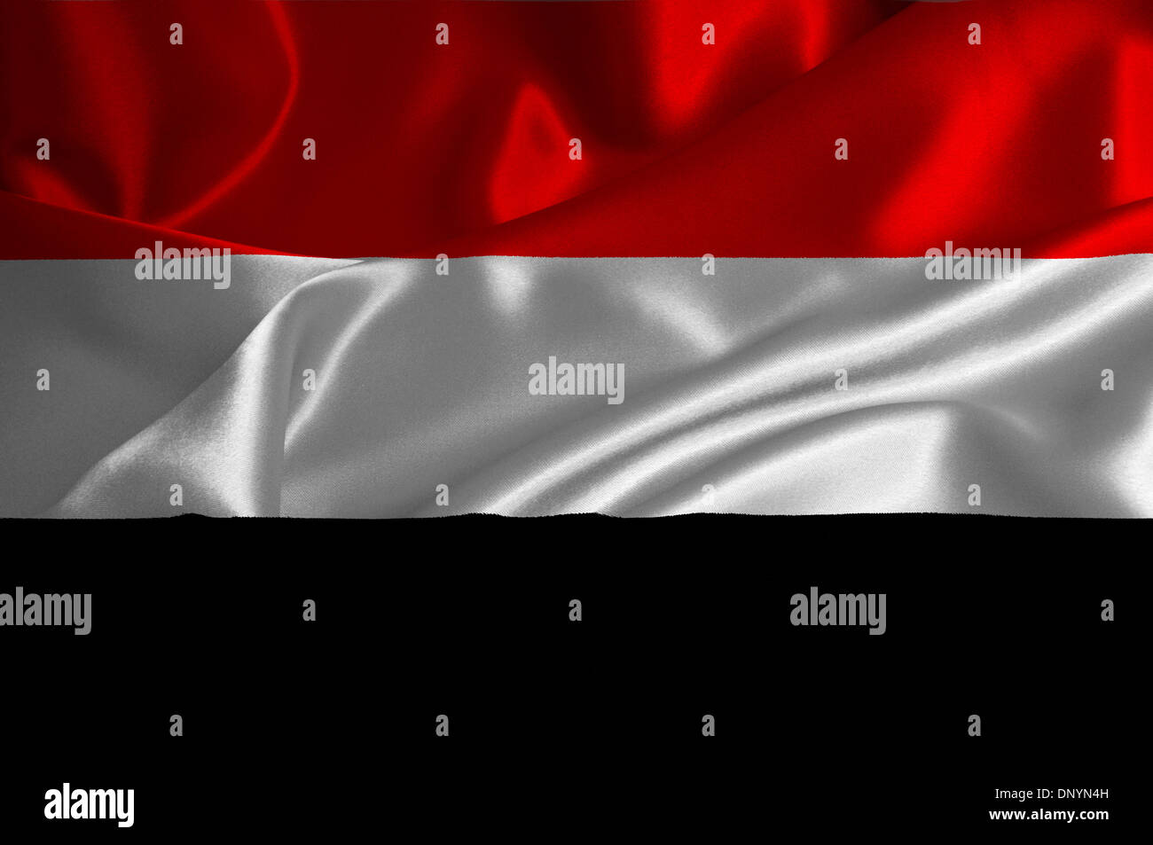 Yemen flag on satin texture. Stock Photo