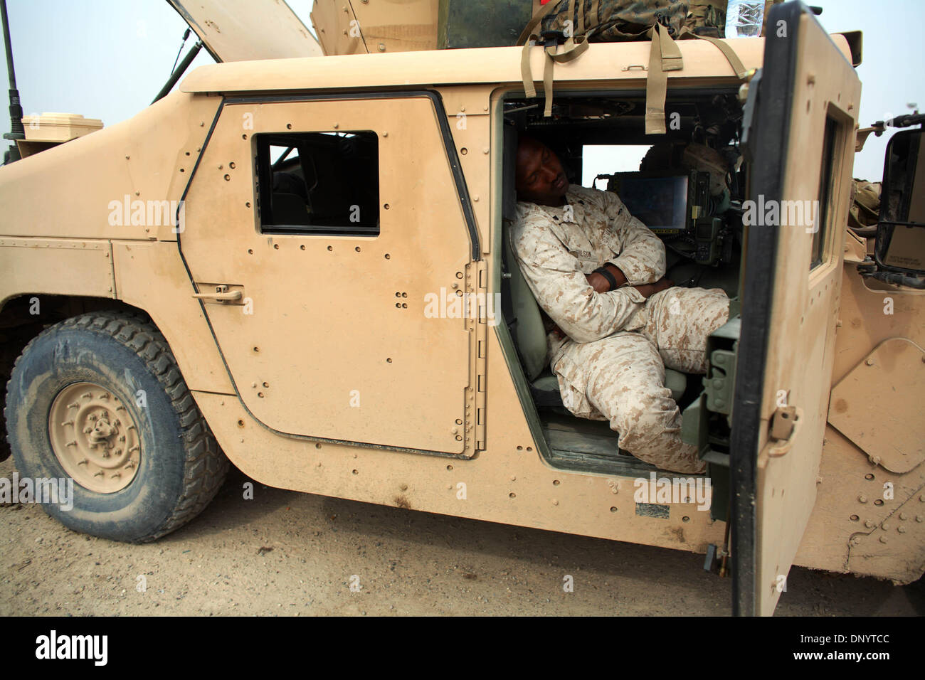 Feb 08, 2006; Al-Falujah, IRAQ; A marine from Weapons company 2nd marine division, 2nd battalion, 6th marine regiment, RCT-8, 4th platoon (callsign Black Label) takes a catnap in his HUMVEE between patrols of the Iraqi city of Al-Falujah. Mandatory Credit: Photo by Toby Morris/ZUMA Press. (©) Copyright 2006 by Toby Morris Stock Photo