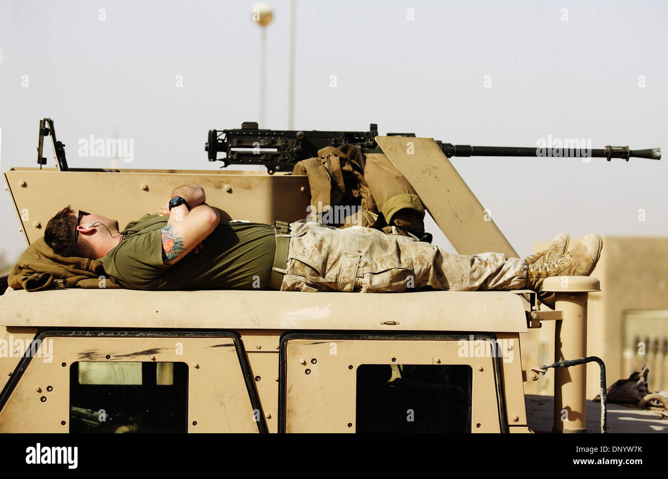 Feb 11, 2006; Al-Falujah, Anbar, IRAQ; A marine from Weapons company 2nd marine division, 2nd battalion, 6th marine regiment, RCT-8, 4th platoon takes a nap on the top of his Humvee between patrols of the Iraqi city of Al-Falujah. Mandatory Credit: Photo by Toby Morris/Toby Morris Photo. (©) Copyright 2006 by Toby Morris Stock Photo