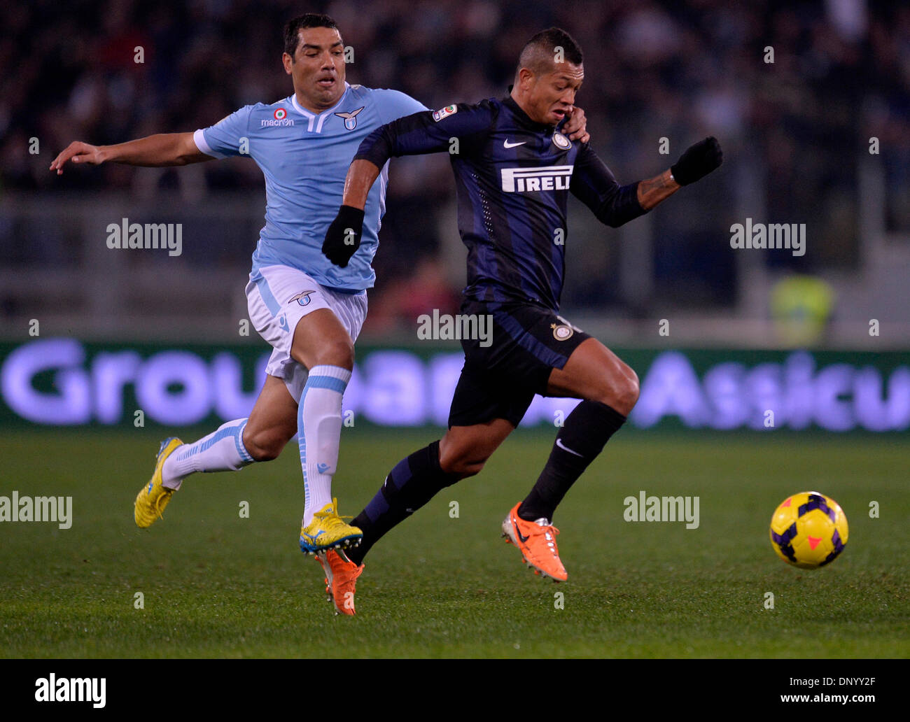 Rome, Italy. 6th Jan, 2014. Andre Dias (L) of Lazio vies with Fredy Guarin of Inter Milan during their Italian Serie A soccer match in Rome, Italy, Jan 6, 2014. Lazio won 1-0. Credit:  Alberto Lingria/Xinhua/Alamy Live News Stock Photo