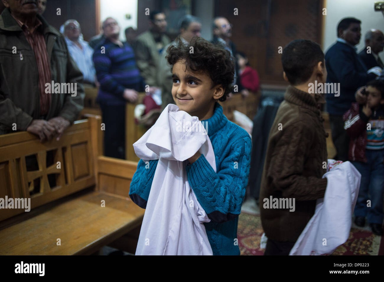 Cairo, Egypt. 7th Jan, 2014. A Coptic altar boy is to change clothes before the Coptic Christmas Eve mass at the Abo Sefen church in the Maadi district of Cairo, capital of Egypt, on Jan. 6, 2014. Coptic Orthodox Christmas falls on Jan. 7, when Egypt's Copts, who make up 10 percent of the Egyptian population, celebrate the feast. Credit:  Pan Chaoyue/Xinhua/Alamy Live News Stock Photo