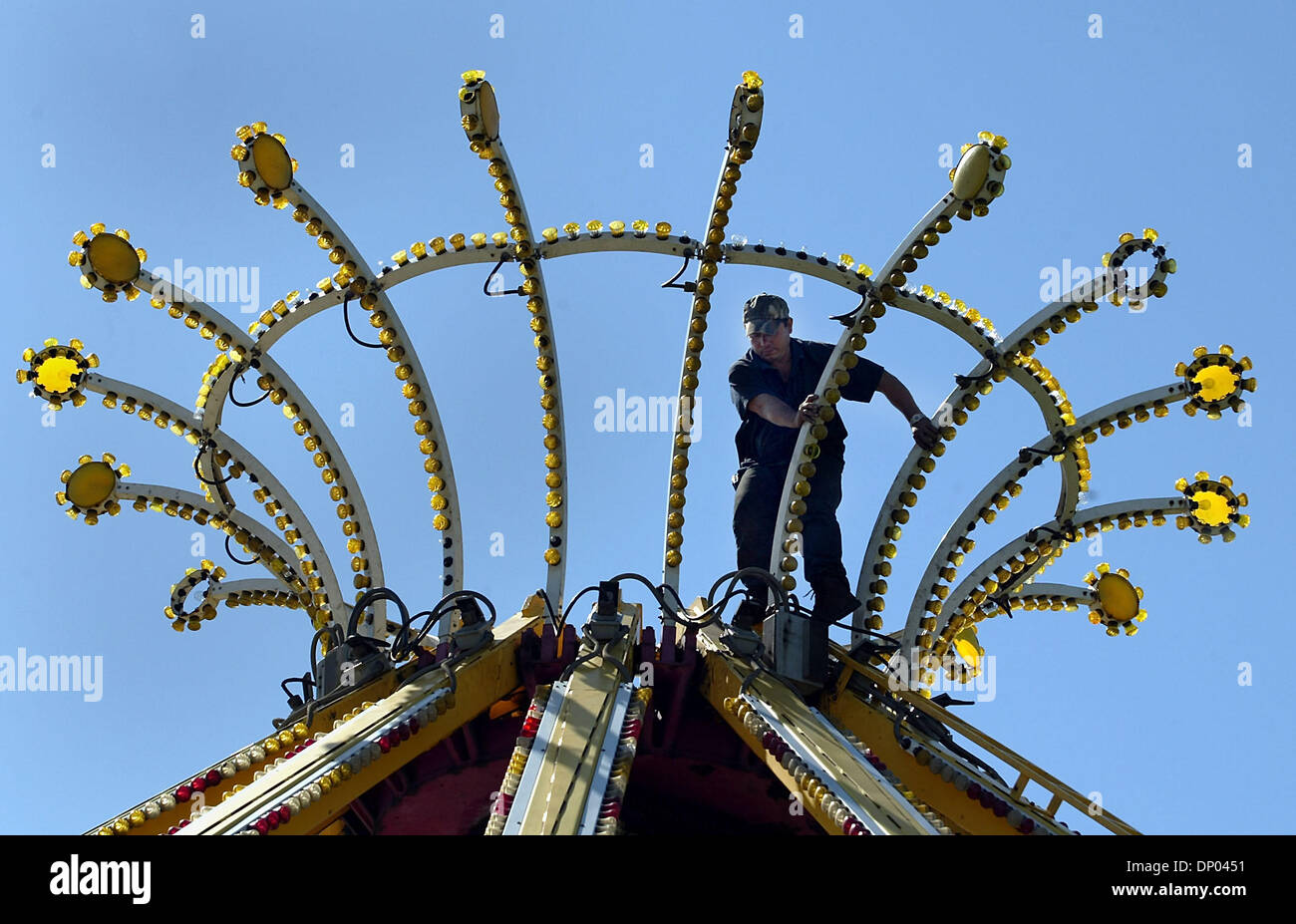 Feb 28, 2006; Delray Beach, FL, USA; A carnival worker from Hildebrand  Rides walks among the lights atop the YoYo ride as they set up 26  mechanical rides for this year's 39th