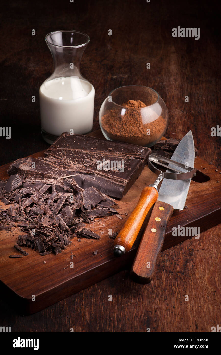 Chocolate bars and ingredients on a wooden table Stock Photo