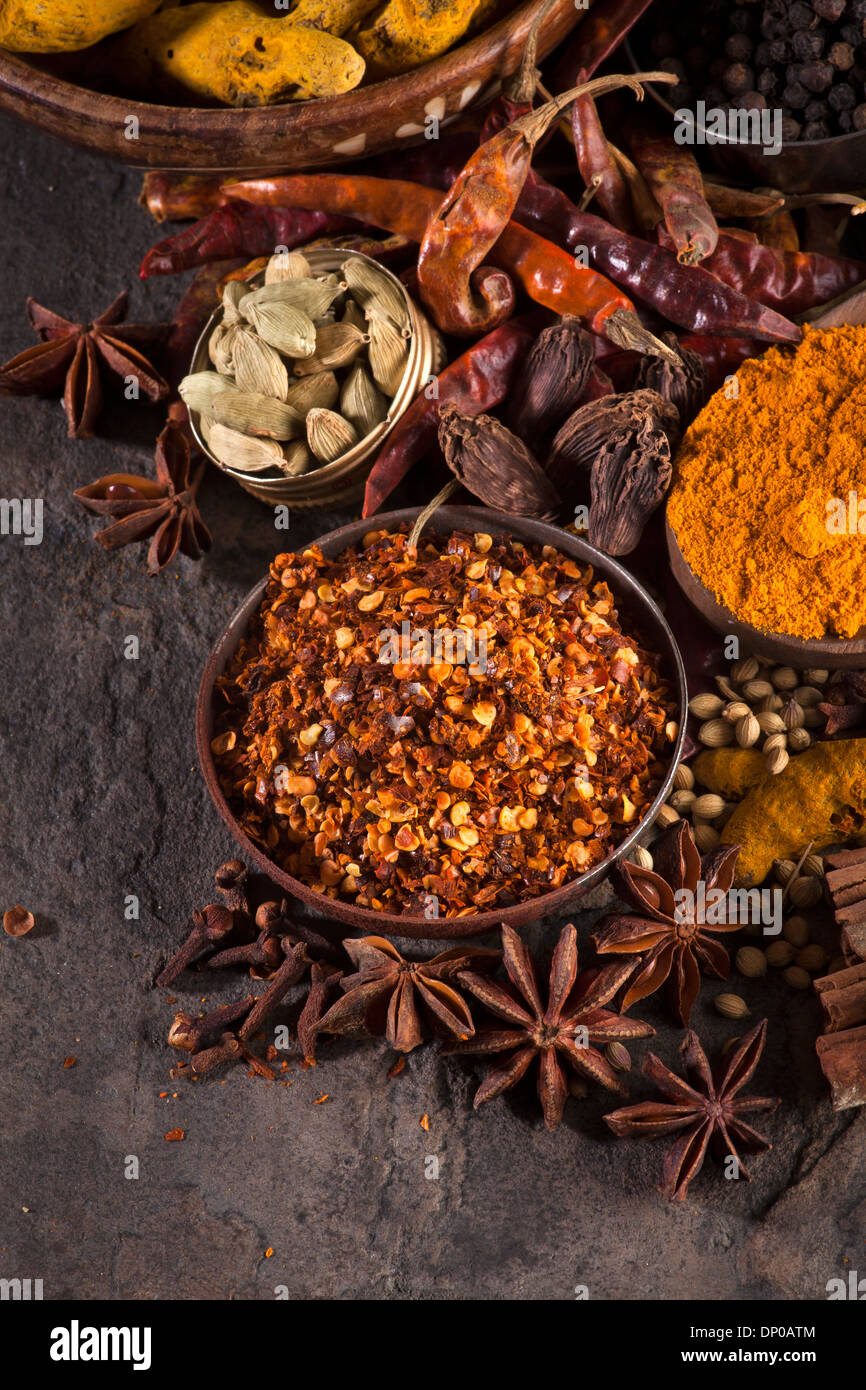Indian spices/ Chili Flakes, Turmeric, Chili , Cardamom, Star Anise, Black Pepper Stock Photo