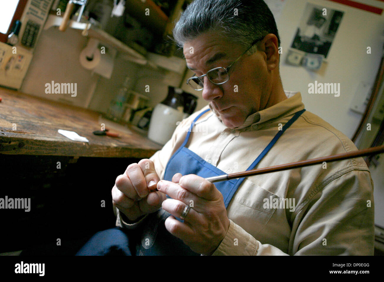 Mar 13, 2006; Berkeley, CA, USA; Bows are repaired and restrung with horsetail hair. Tired of working for Caterpillar as a mechanic, and with an appreciation for violin music, Jay Ifshin spent three years at the violin-making school in Salt Lake City. With schooling completed, Jay bought a small violin shop in Berkeley that had been in business since the 1930's. At that time, there Stock Photo