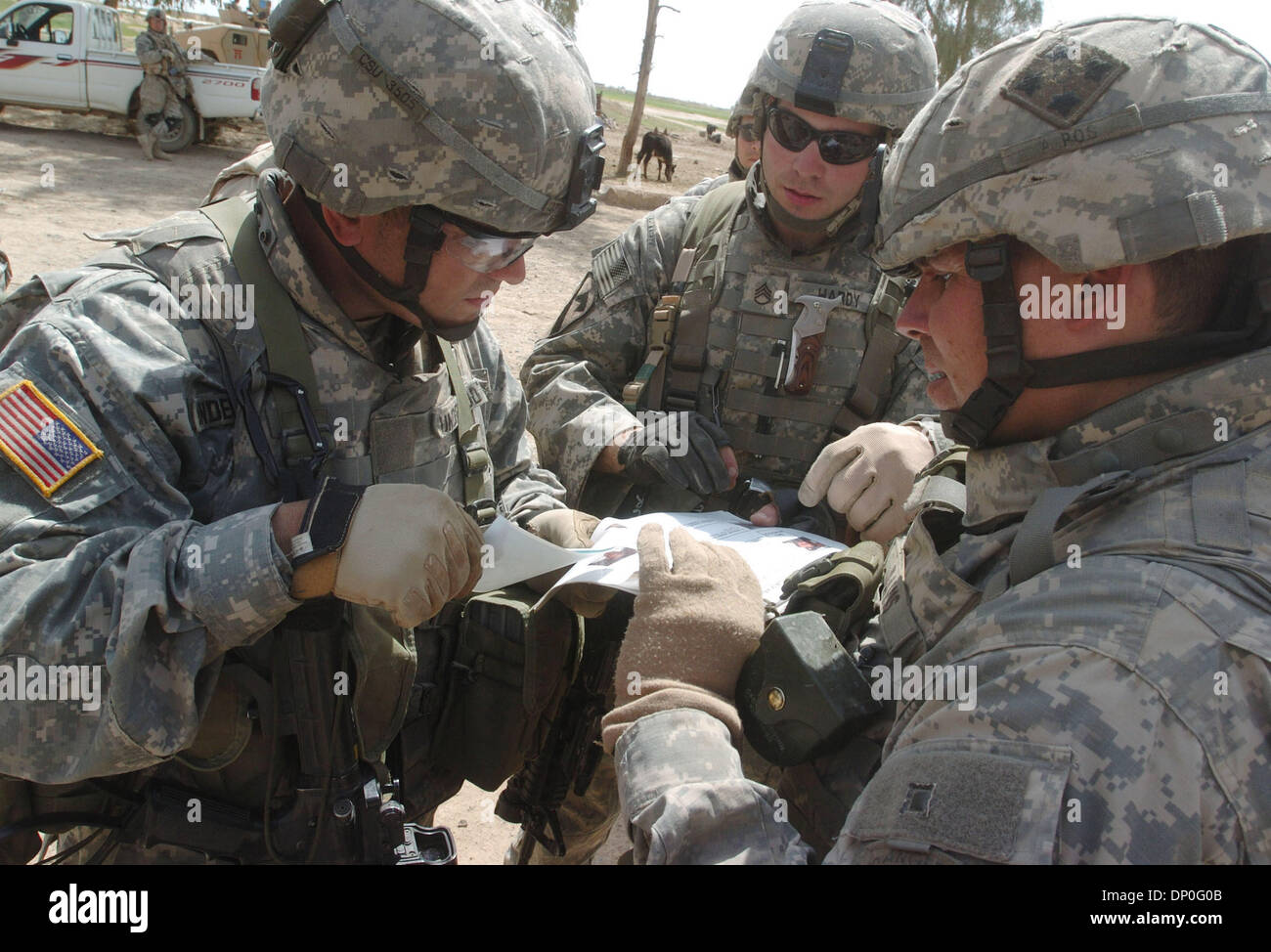Mar 18, 2006; Saluhiddin, IRAQ; Soldiers from Troop C, 2-9 Cavalry match identification cards of a suspected insurgent during Operation Swarmer March 18, 2006. The man, allegedly the cavalry squadron's most wanted insurgent, and one of his brothers was later detained. Nearly 1,500 US and Iraqi soldiers, 50 attack and transport helicopters and 200 ground vehicles were out during the Stock Photo
