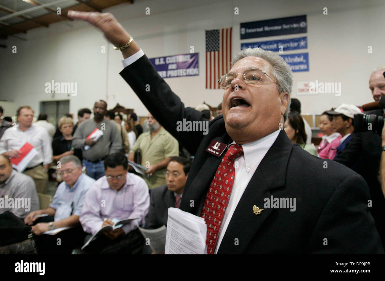 Mar 23, 2006; San Diego, CA, USA; Auctioneer Ringman JIM BUZZELLA relays to the auctioneer that this is the last bid from a bidder during the federal forfeiture auction of items seized by the U.S. Government from former Congressman Randy 'Duke' Cunningham when he pled guilty to conspiracy and tax evasion. Cunningham is now serving an 8 year four month sentence in federal prison. Ma Stock Photo