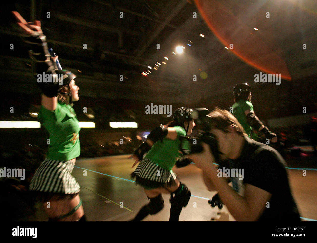 Mar 24, 2006; St. Paul, MN, USA; Minnesota RollerGirls skater Rolls Wilder  (Bridgett Donnelly) of the Garda Belts, left, and teammate Honey Hollow  (Jessi Schulte) head out onto makeshift track during introductions