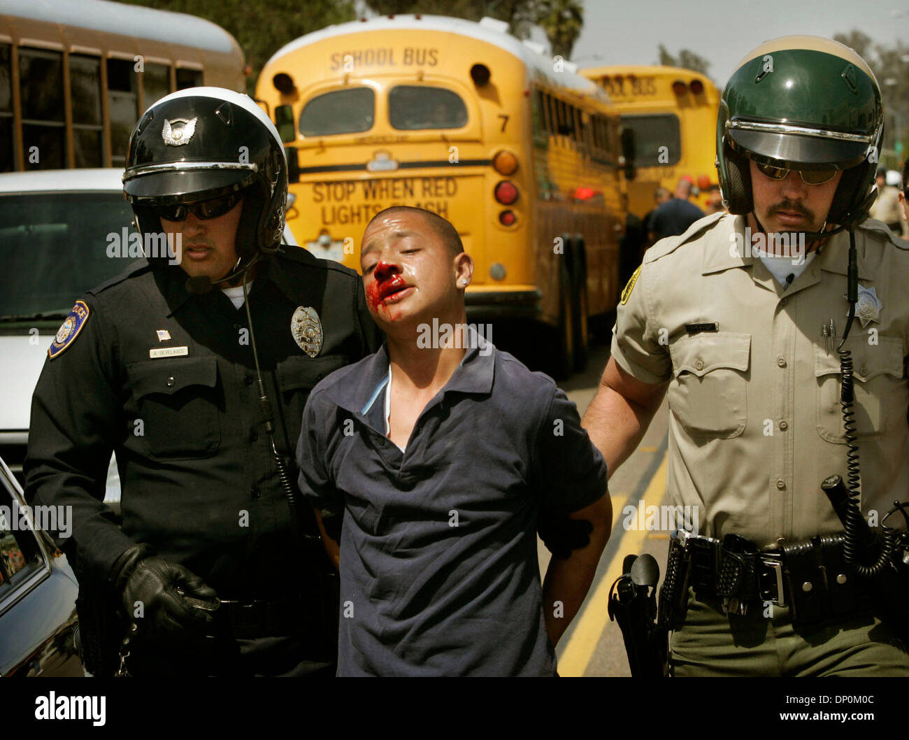Mar 27, 2006; Escondido, CA, USA; Police personnel take a student into