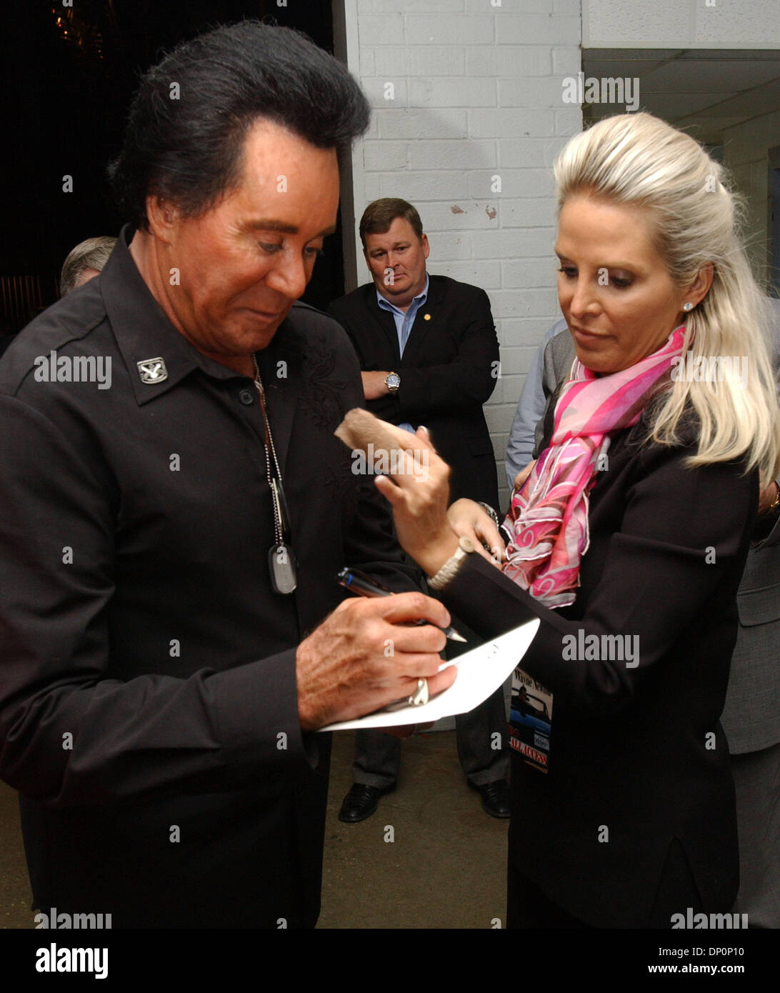 Mar 31, 2006; Fayetteville, NC, USA; Singer WAYNE NEWTON and wife KATHLEEN NEWTON looks on as Mr. Newton signs an autograph  after Mr. Newton performed  at  the Crown Theatre located in Fayetteville, NC.  Earlier in the day Mr. Newton visited the local Veterans Hospital patients and spoke with troops at Fort Bragg located in North Carolina. Mandatory Credit: Photo by Jason Moore/ZU Stock Photo