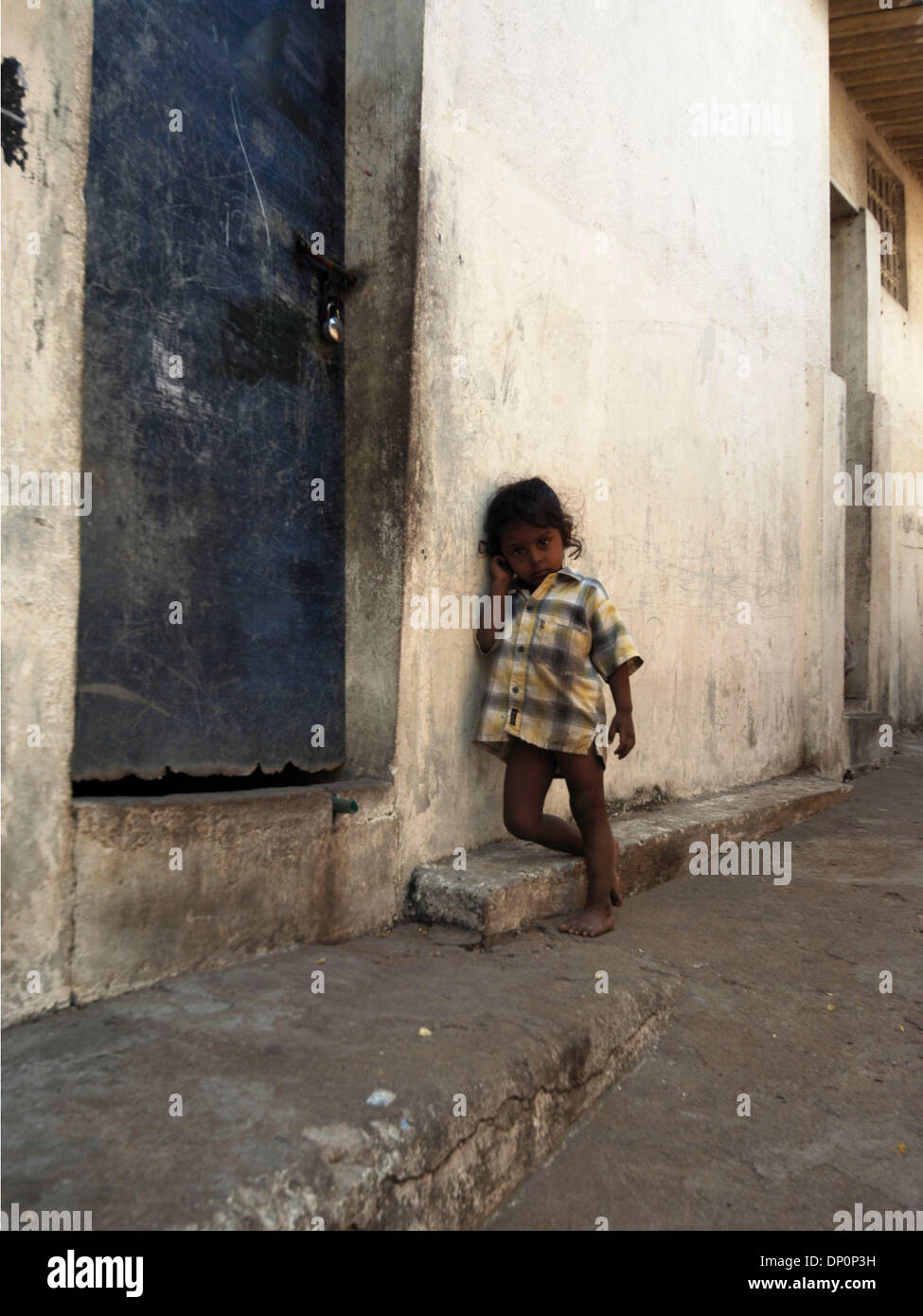 Mar 31, 2006; Chennai, Tamil Nadu, INDIA; Indian child hanging out infront of her house, which is located on the Adyar river. The Adyar river is where all  the raw sewage seems to run to. Mandatory Credit: Photo by Daniel Wilkinson/Daniel Wilkinson. (©) Copyright 2006 by Daniel Wilkinson Stock Photo