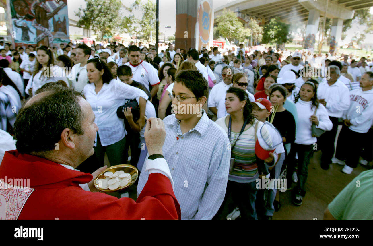 Apr 09, 2006; San Diego, CA, USA; FATHER JOHN AUTHER, left, of Our Lady of Guadalupe Church performs Communion during Palm Sunday Mass at Chicano Park. Mandatory Credit: Photo by Howard Lipin/SDU-T/ZUMA Press. (©) Copyright 2006 by SDU-T Stock Photo