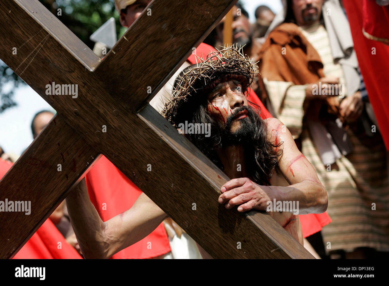 Apr 14, 2006; San Antonio, TX, USA; Derly Cirlos, portraying Jesus in San Fernando Cathedral's annual Via Crucis, struggles to rise after falling to the ground on his way through downtown San Antonio. Mandatory Credit: Photo by Mike Kane/ZUMA Press. (©) Copyright 2006 by San Antonio Express-News Stock Photo