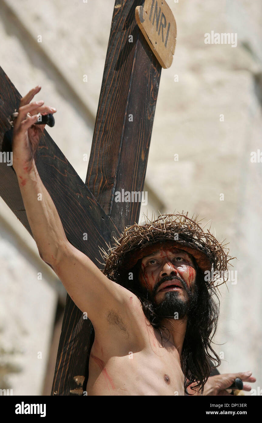 Apr 14, 2006; San Antonio, TX, USA; Derly Cirlos, portraying Jesus, is hoisted on a cross before being crucified during San Fernando Cathedral's annual Via Crucis in downtown San Antonio. Mandatory Credit: Photo by Mike Kane/ZUMA Press. (©) Copyright 2006 by San Antonio Express-News Stock Photo