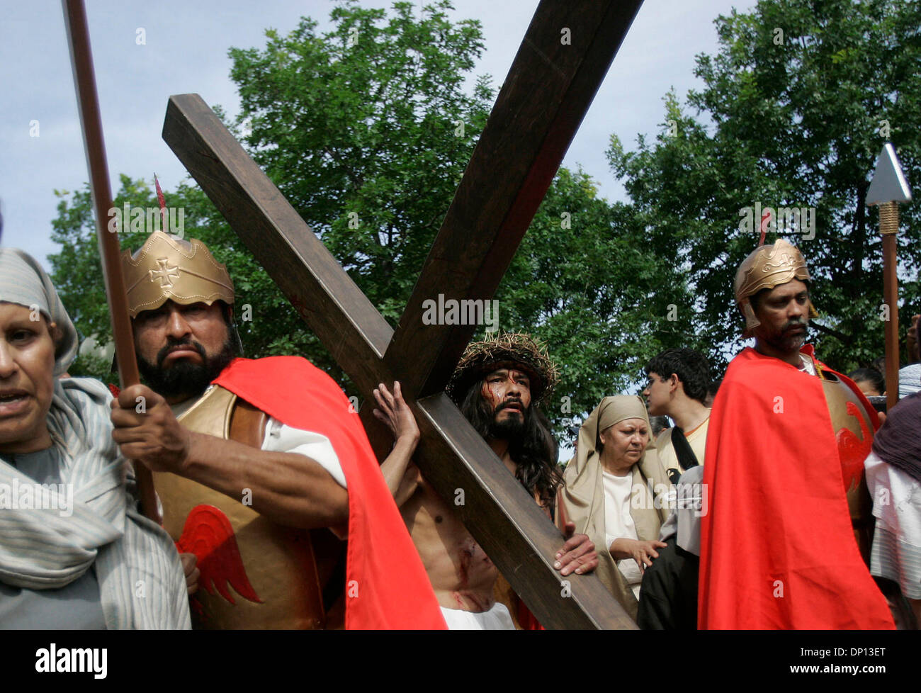 Apr 14, 2006; San Antonio, TX, USA; Derly Cirlos, portraying Jesus in San Fernando Cathedral's annual Via Crucis carrying his own cross on his way to being crucified, passes through Milam Park in San Antonio. Mandatory Credit: Photo by Mike Kane/ZUMA Press. (©) Copyright 2006 by San Antonio Express-News Stock Photo