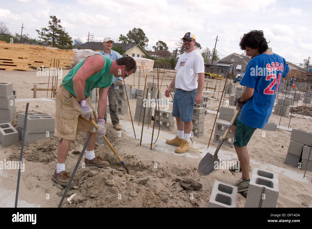 Apr 18, 2006; New Orleans, LA, USA; Musician Fredy Omar (R) puts in his 'sweat equity' as the first musician to be approved for a house in Habitat for Humanity's Musician's Village in New Orleans' Upper Ninth Ward. Working with him are members of the First Presbyterian Church in Beaver, PA. They are (L-R) Chuck Verrett, who owns an ad agency in Beaver Falls; Jack Hall, a software d Stock Photo
