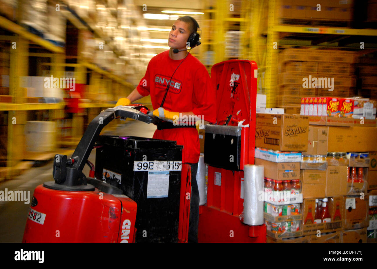 Apr 24, 2006; Hopkins, MN, USA; With a computer radio voice in his ear giving him instructions, Marcell Graham rides the aisles of the 473,000 square foot Supervalu distribution center in Hopkins gathering orders for stores.  The company is building an additional highly automated 579,000 square foot distribution center across the street. Mandatory Credit: Photo by Glen Stubbe/Minne Stock Photo