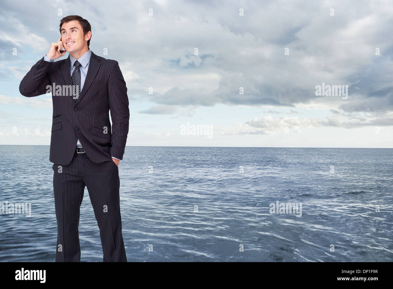 Composite image of happy businessman phoning Stock Photo