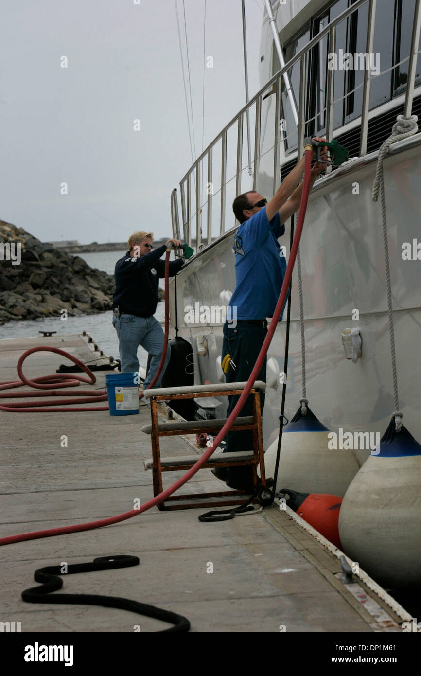 May 05, 2006; San Diego, CA, USA; Harbor Island Fuel Dock manager KEVIN DAY, forground, and captain CHRIS TROUPE, rear, worked in tandem to fuel the yacht 'ReelPainII' at the fuel dock. Mandatory Credit: Photo by John Gibbins/SDU-T/ZUMA Press. (©) Copyright 2006 by SDU-T Stock Photo