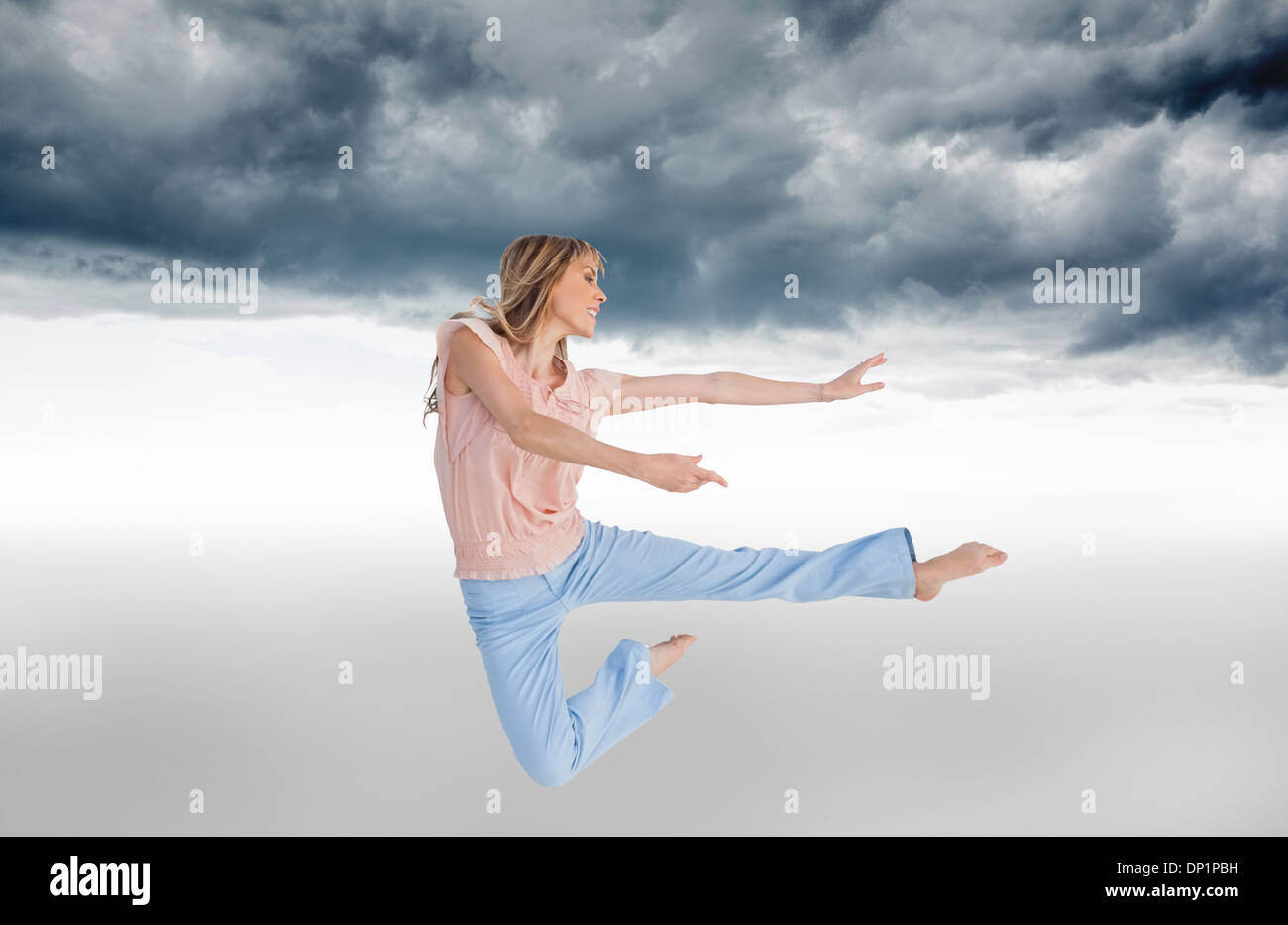 Composite image of woman doing dance pose Stock Photo