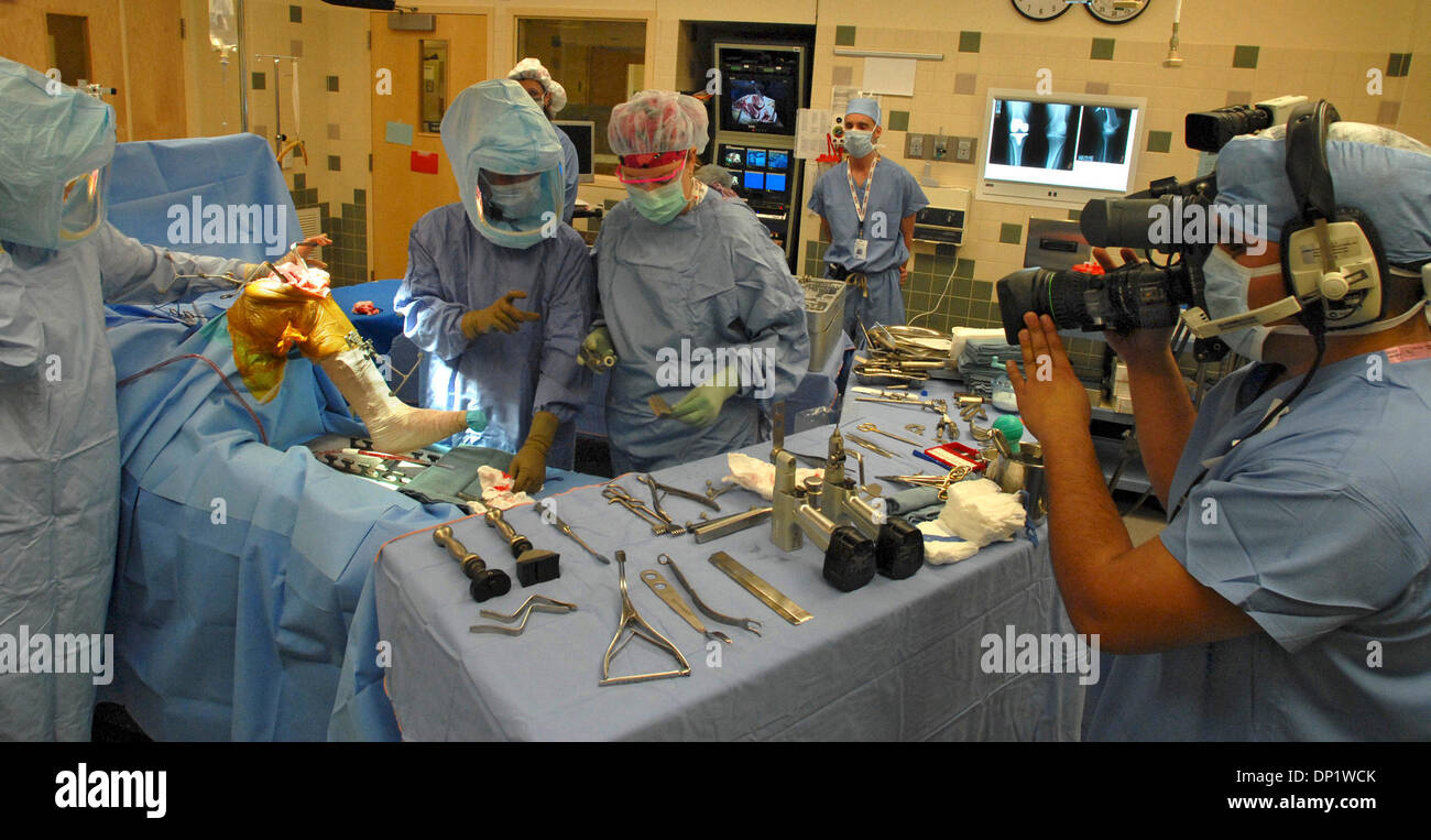 May 09, 2006; Woodbury, MN, USA; Dr. DAN HOEFFEL (left center) chooses his surgical implements during a live webcast of computer-assisted knee replacement surgery.  Orthopedic physician assistant MARCIA RUNNING (left) and surgical tech RHONDA JARNOT (right) work with the doctor as ORLive photographer TONY JOHNSON tapes the action. Woodwinds Health Campus is one of an increasing num Stock Photo