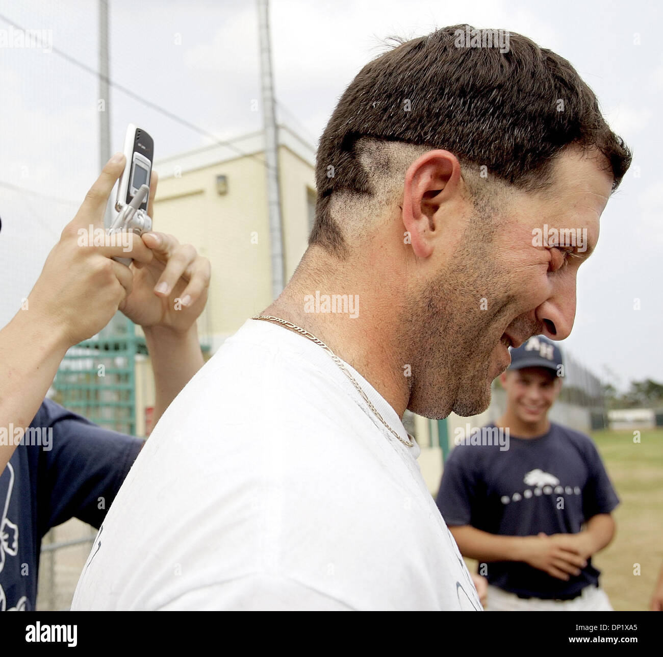 May 11, 2006; Delray Beach, FL, USA; American Heritage baseball coach Carm  Mazza poses for a camera phone after having his hair cut by players after  promising to do so after his