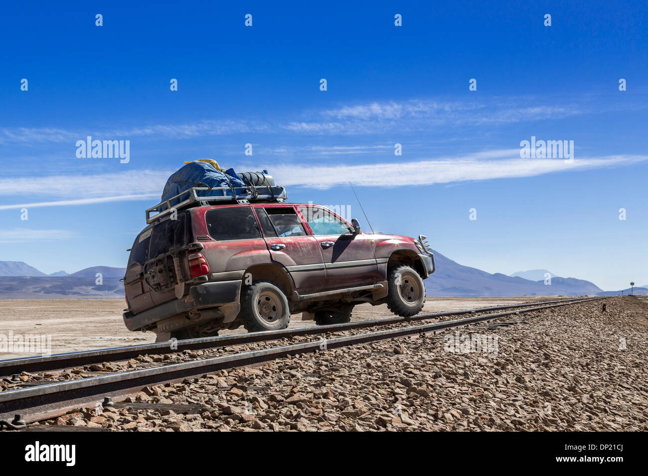 Car crossing railroad tracks, Altiplano, Andean Plateau, Andes, Bolivia Stock Photo