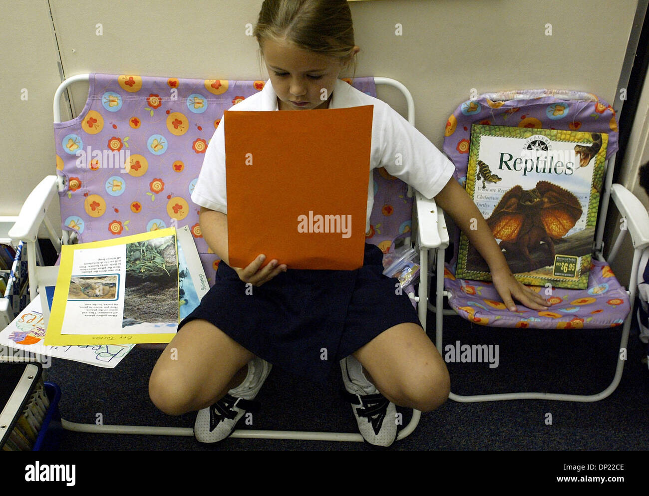 May 15, 2006; Boca Raton, FL, USA; Sydney Pennington, 7, saves a place for her reading buddy, Hannah Skiff, 8, while reading about reptiles at A. D. Henderson University school, a charter lab school on the Boca Raton campus of Florida Atlantic University.  Mandatory Credit: Photo by Chris Matula/Palm Beach Post/ZUMA Press. (©) Copyright 2006 by Palm Beach Post Stock Photo