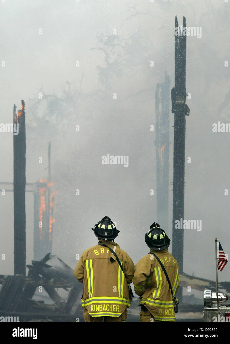 May 16, 2006; Boca Raton, FL, USA; Boynton Beach Fire-Rescue firefighters Jeff Kinbacher, left, and Mason Pearce watch as the old T-3 building on the Boca Raton Florida Atlantic University campus burns to the ground Tuesday, May 16, 2006. Units from Boca Raton, Delray Beach, Boynton Beach, Palm Beach County and Deerfield Beach responded to the blaze. The building dates from World W Stock Photo