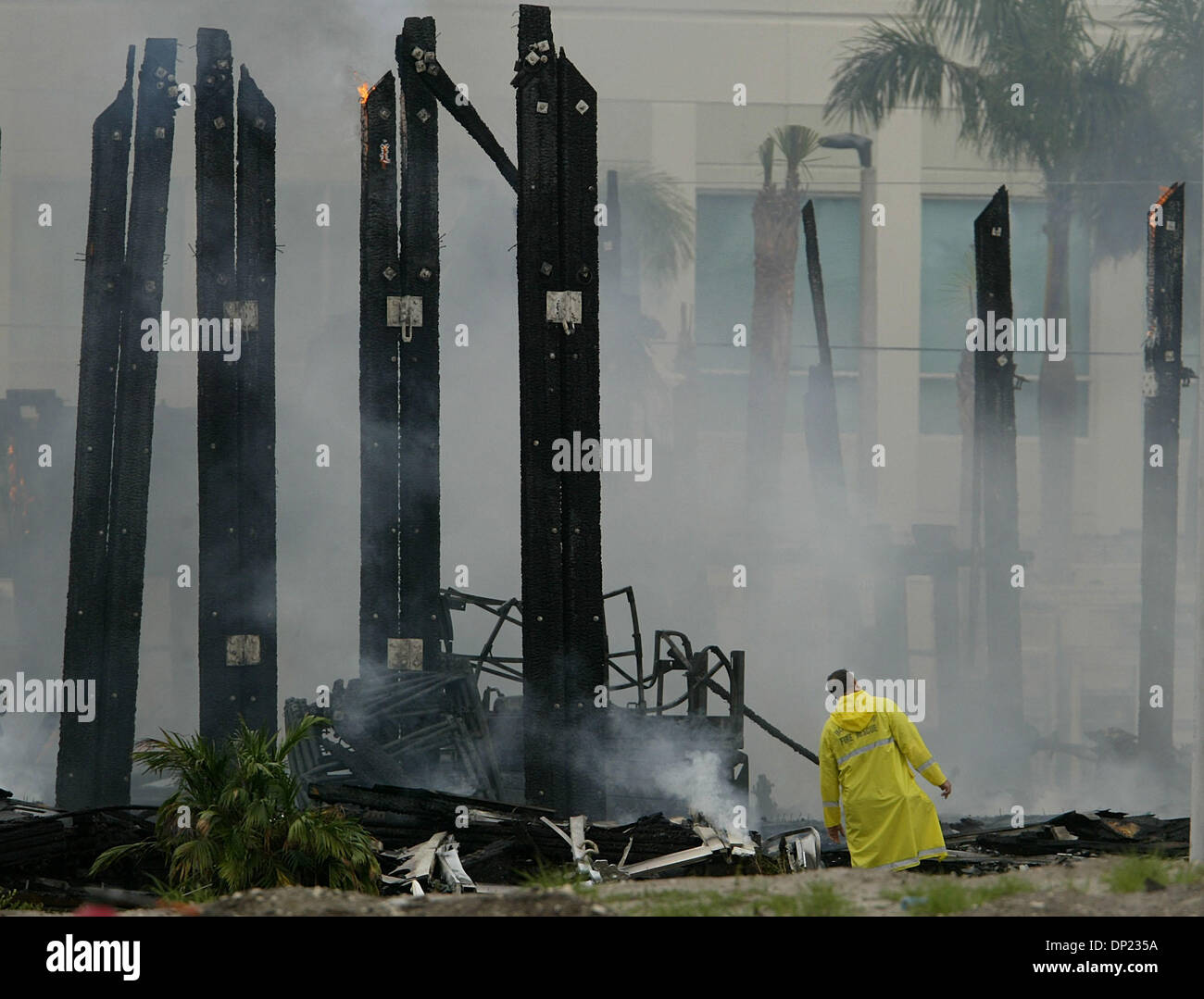 May 16, 2006; Boca Raton, FL, USA; A Boca Raton firefighter inspects the still-burning pine support beams of the old T-3 building on the Boca Raton Florida Atlantic University campus as the structure burns to the ground Tuesday, May 16, 2006. Units from Boca Raton, Delray Beach, Boynton Beach, Palm Beach County and Deerfield Beach responded to the blaze. The building dates from Wor Stock Photo