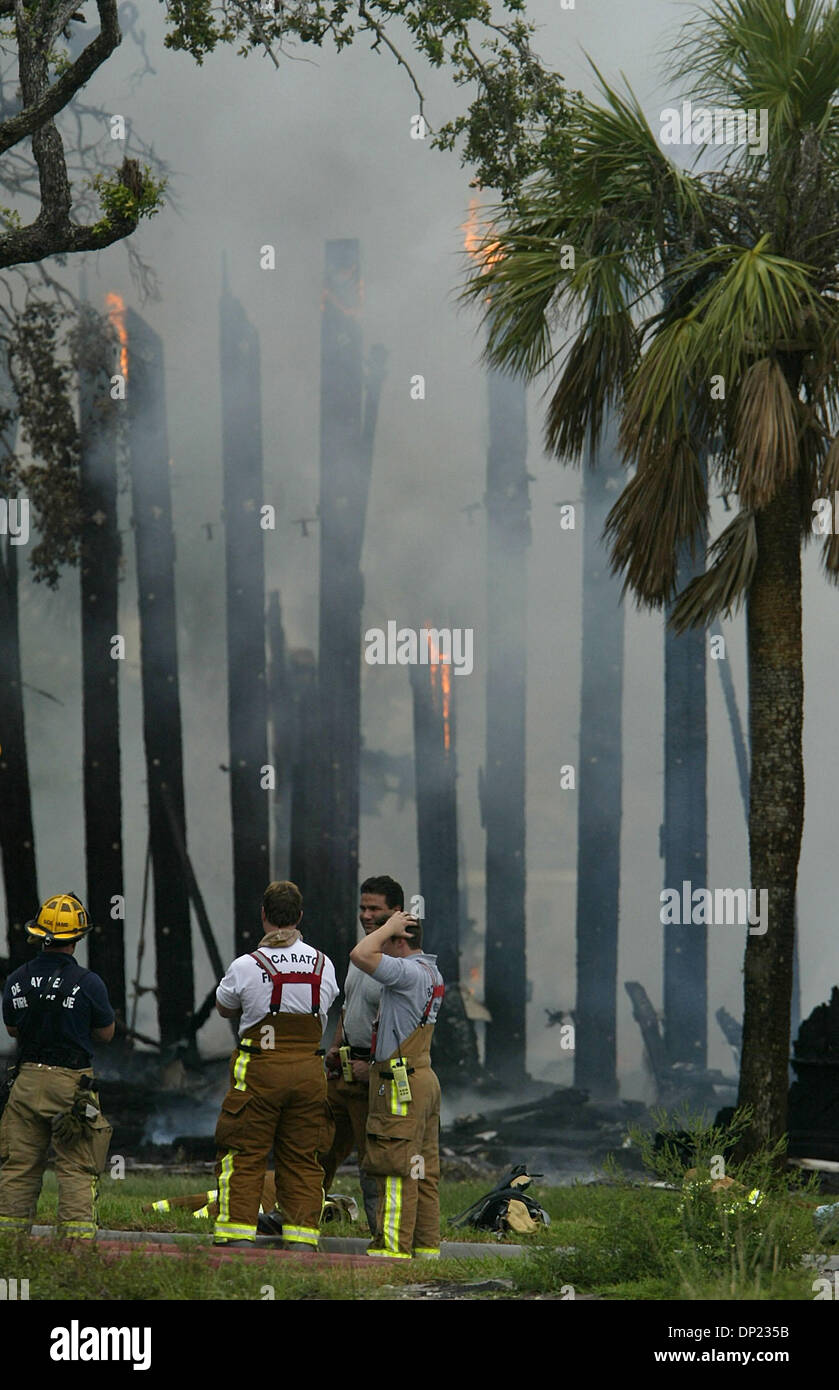 May 16, 2006; Boca Raton, FL, USA; Boca Raton firefighters take a short break as the T-3 building on the Boca Raton Florida Atlantic University campus burns to the ground Tuesday, May 16, 2006. Units from Boca Raton, Delray Beach, Boynton Beach, Palm Beach County and Deerfield Beach responded to the blaze. The building dates from World War II when it was used to house radar technic Stock Photo