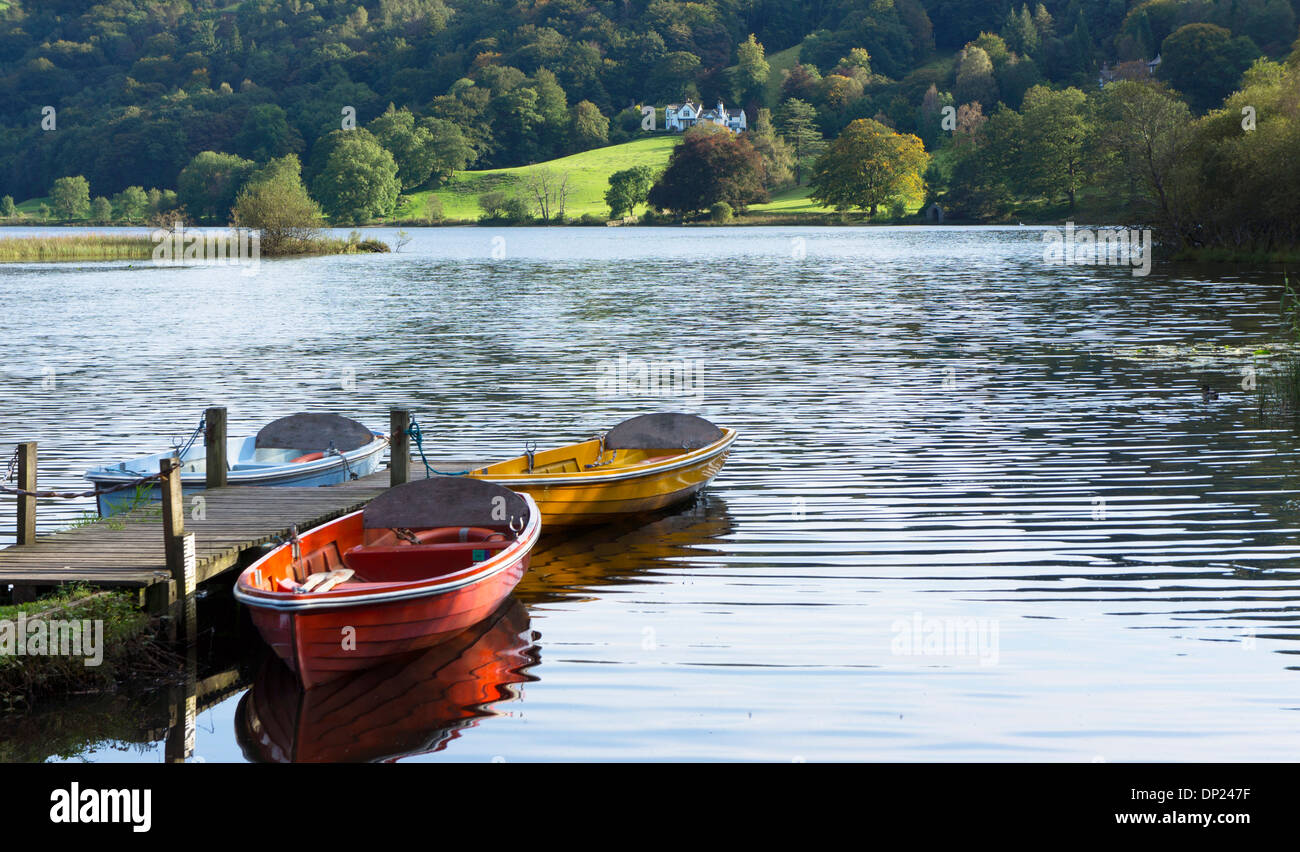 Pleasure boats moored at jetty on lake Grasmere in the English Lake