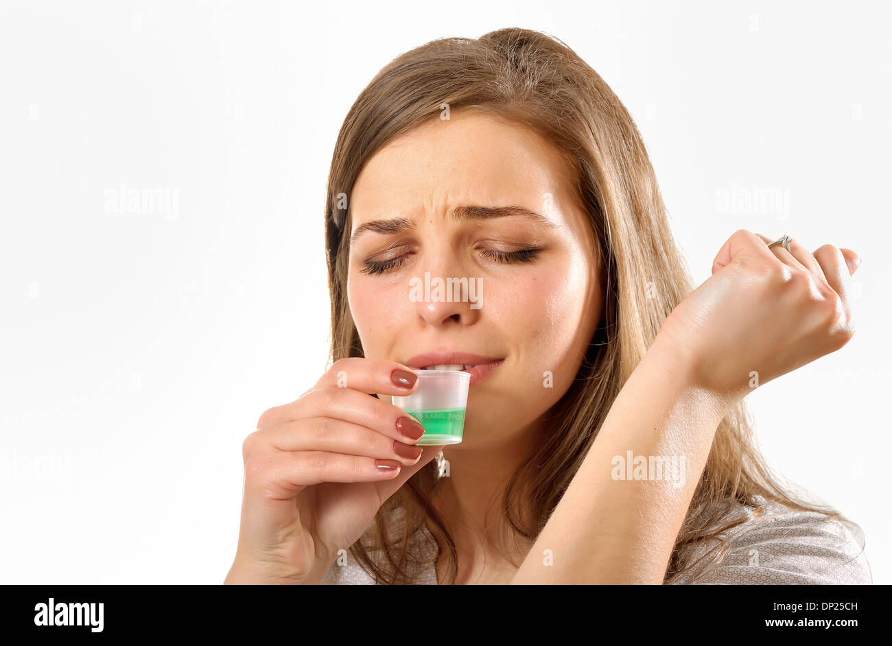 girl taking cough syrup, isolated on white Stock Photo