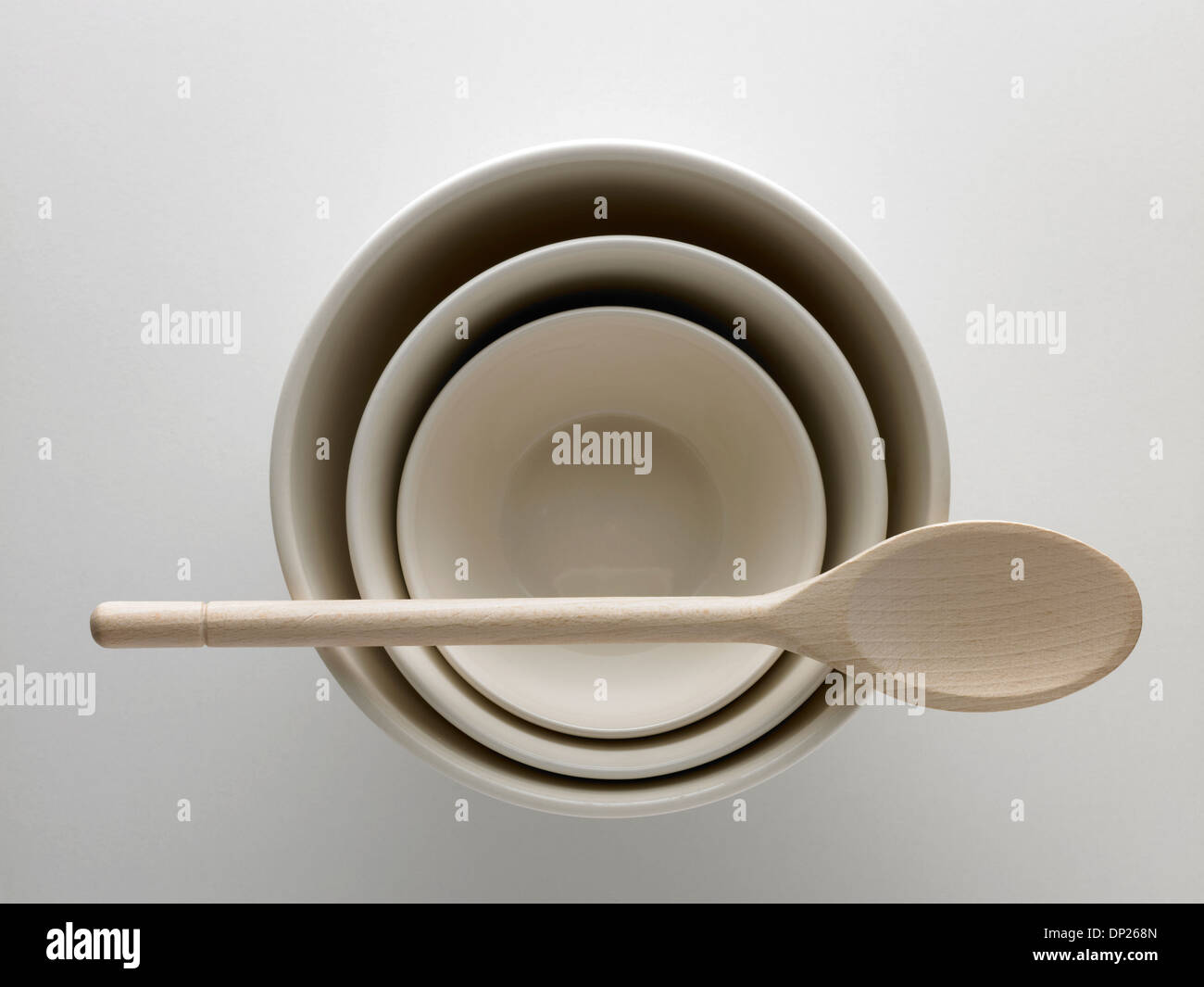 three white bowls and wooden spoon Stock Photo