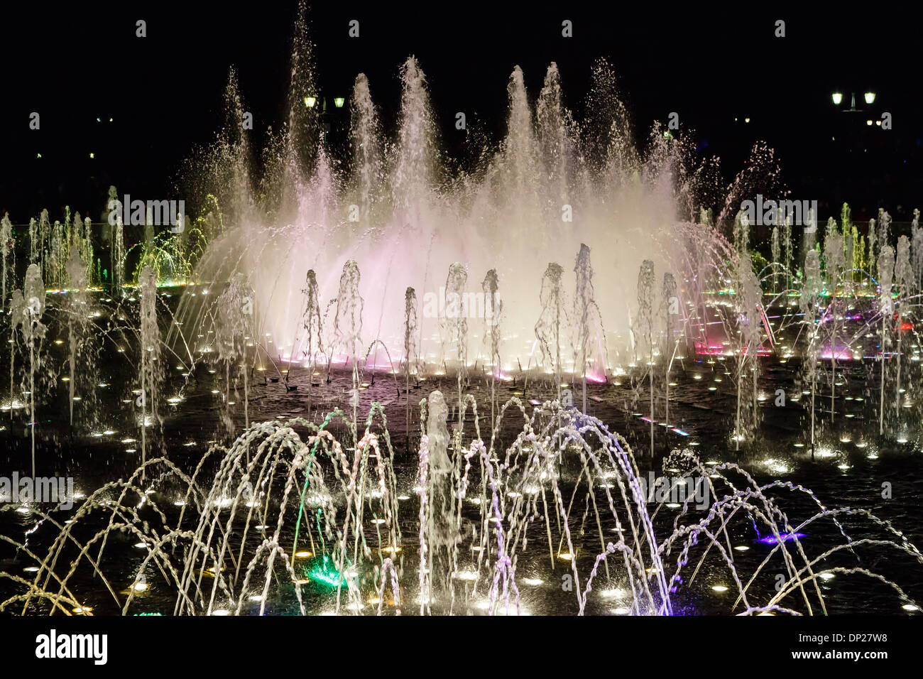 Water streams of the fountain illuminated at night Stock Photo - Alamy