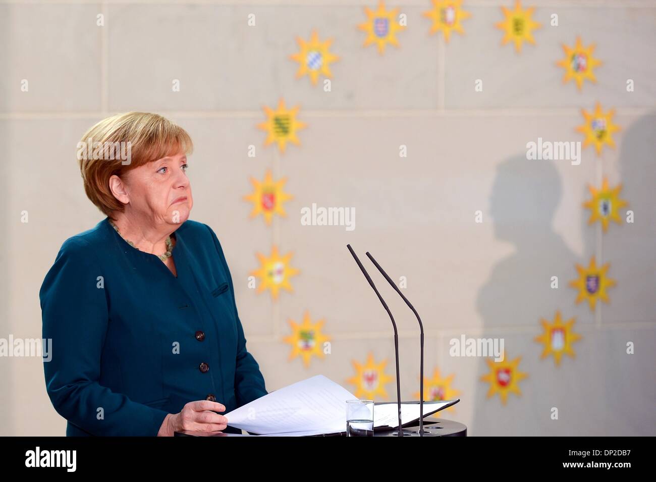 Berlin, Germany. 7th Jan, 2014. German Chancellor Angela Merkel uses crutches during the annual reception for Carolers at the chancellery in Berlin, Tuesday Jan. 7, 2014. German Chancellor Angela Merkel suffered a pelvis injury during ski holidays in the Swiss Alps and will have to cut back on her work schedule for the next three weeks. The signs show the different German cities the Carolers are coming from. Credit:  Goncalo Silva/NurPhoto/ZUMAPRESS.com/Alamy Live News Stock Photo