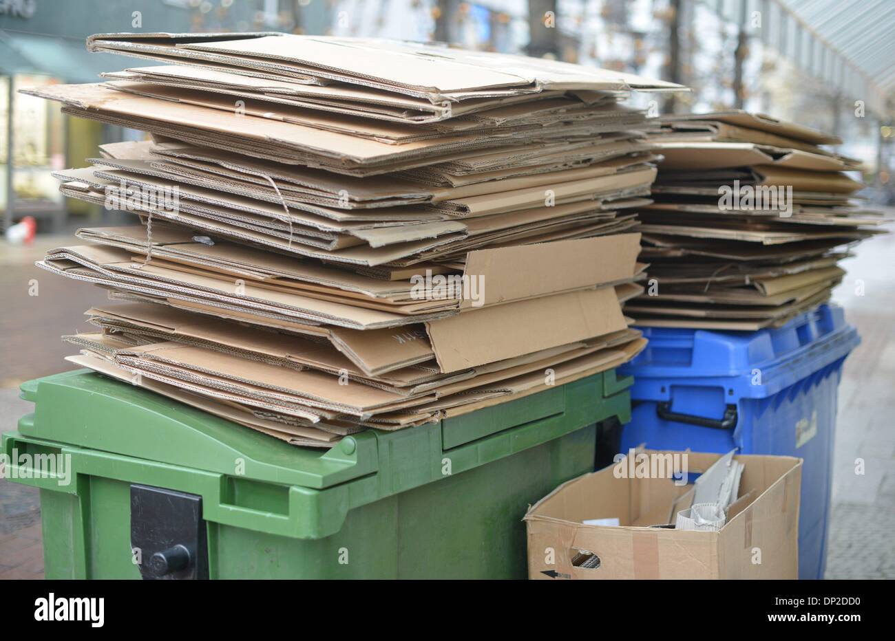 Garbage cans with paperboard are staying on the street to get picked up from the garbage collection in Hannover, Germany, 6. January 2014. Photo: Frank May Stock Photo