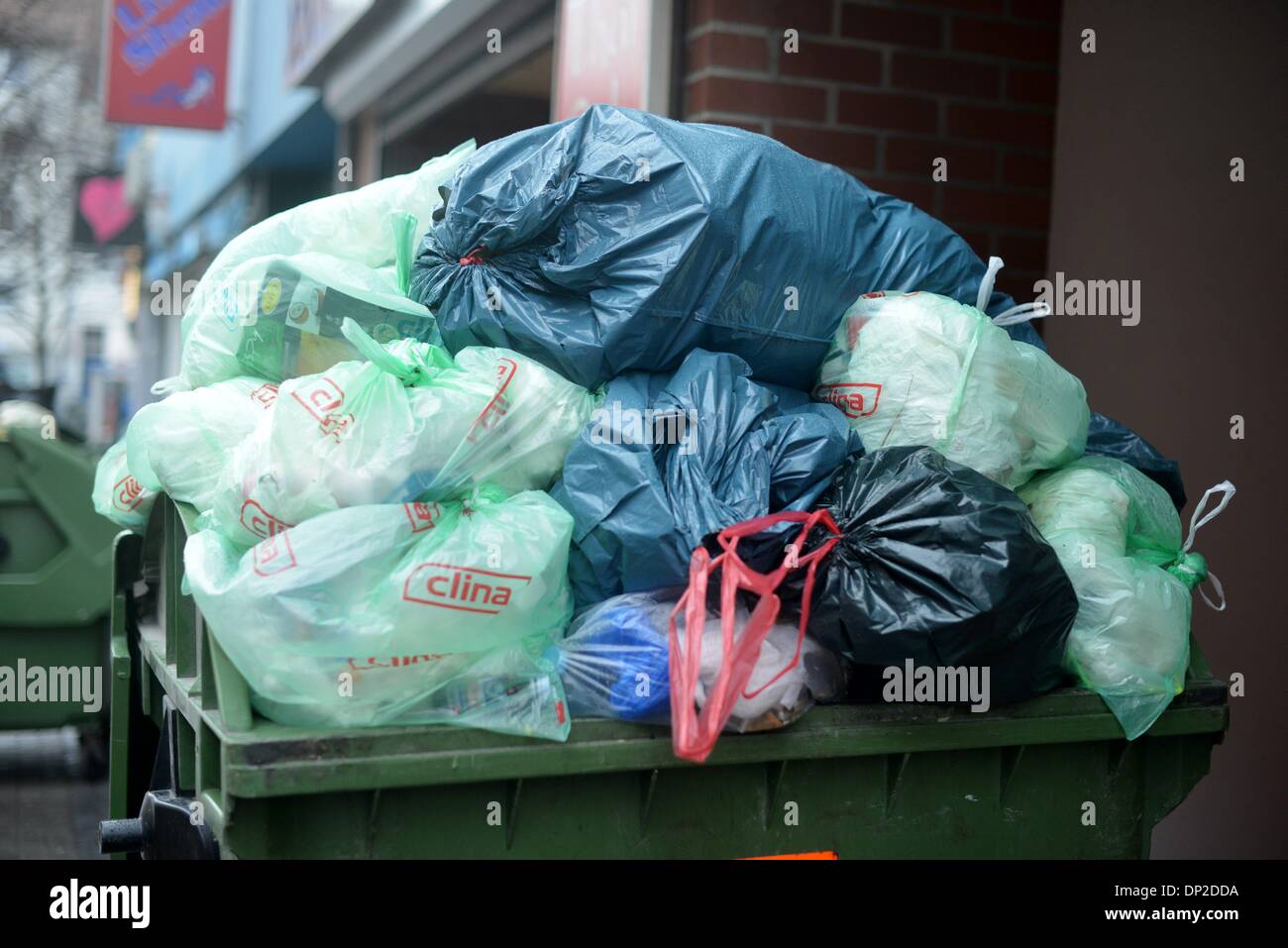 Garbage cans are staying on the street to get picked up from the