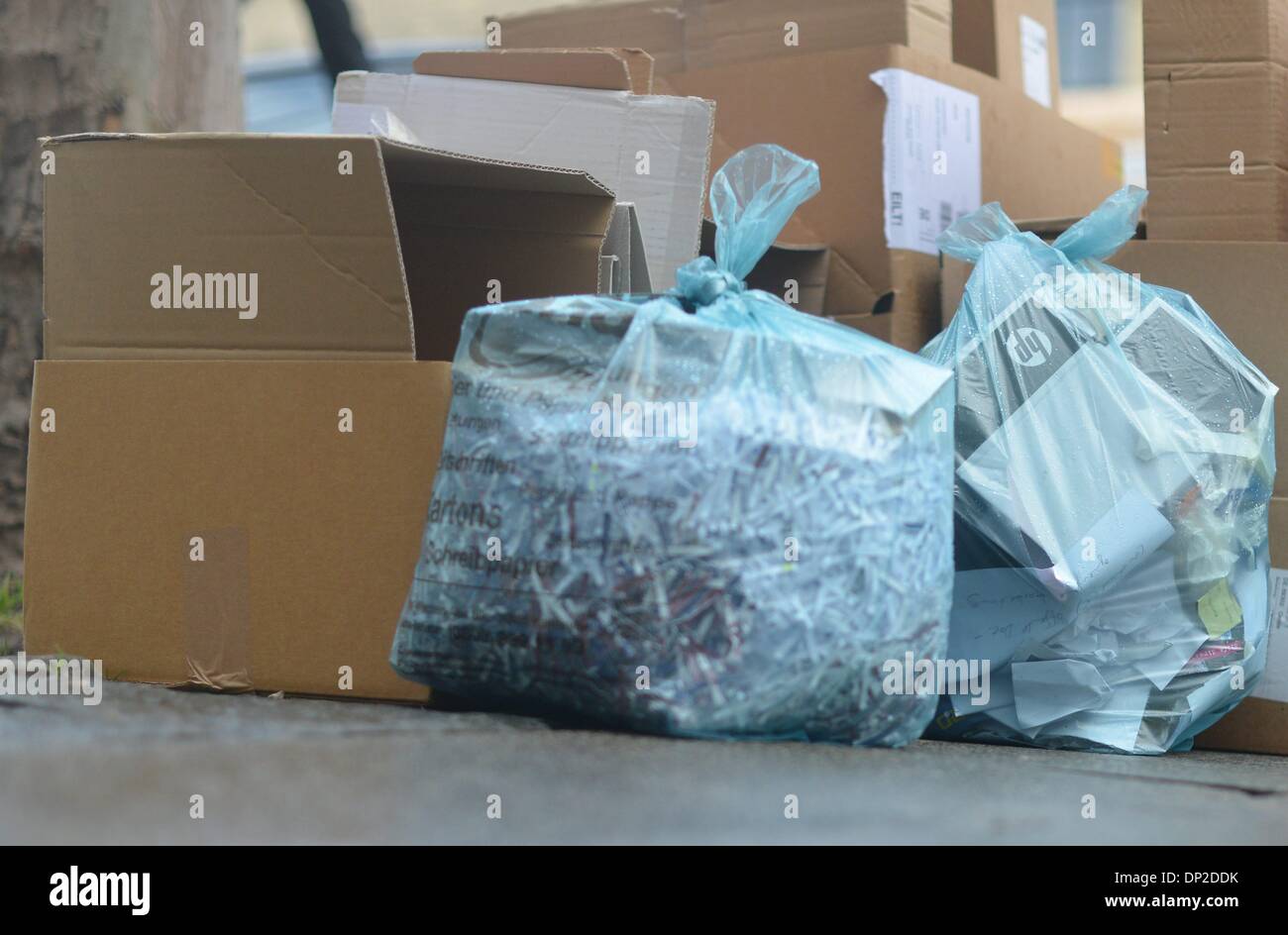 Garbage bags and Paper boxes are laying on the street to get picked up from the garbage collection in Hannover, Germany, 6. January 2014. Photo: Frank May Stock Photo