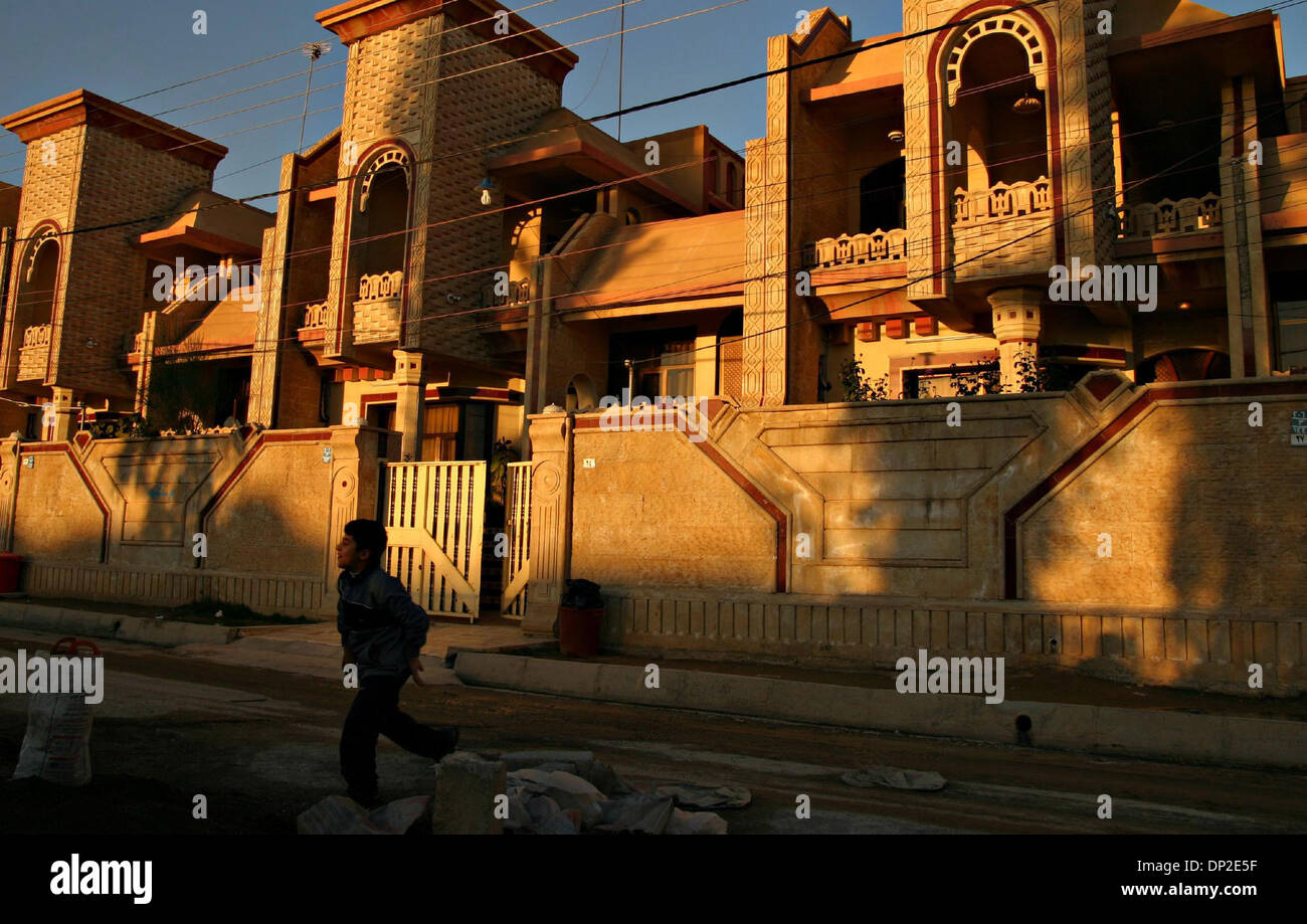 May 31, 2006; Arbil, Kurdistan, IRAQ; A boy runs in front of one of the average mansions in Dolarawa, a Dollar-town, rich suburb of Arbil, Jan 16. 2006. There are many noveau rich suburbs that are mushrooming in the main cities of Kurdsitan. Many people have gotten wealthy due to their close ties to high ranking officials who give them access to profitable contracts and tenders. Th Stock Photo