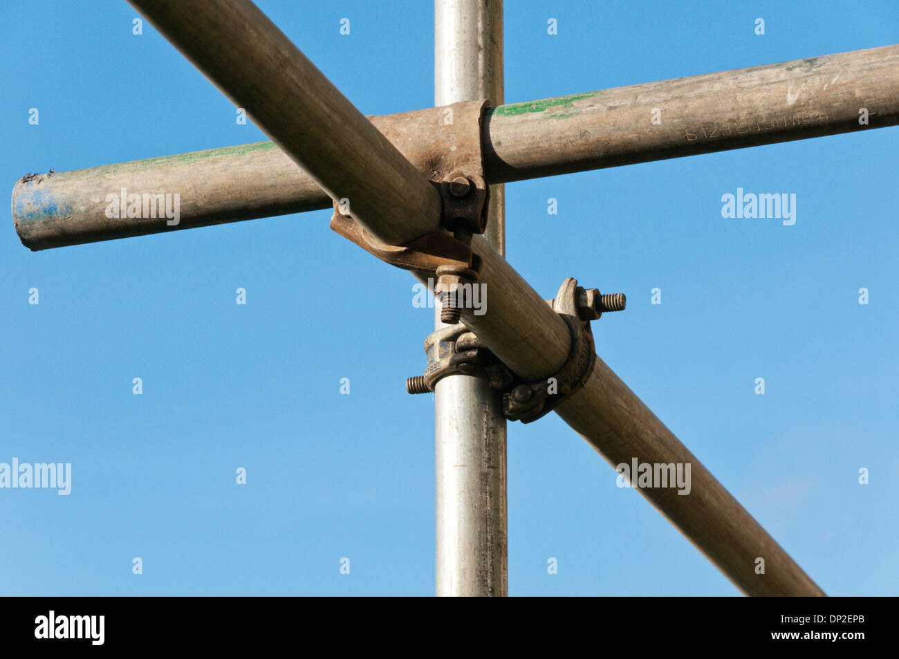 Close up of joint in scaffold poles against a blue sky. Stock Photo