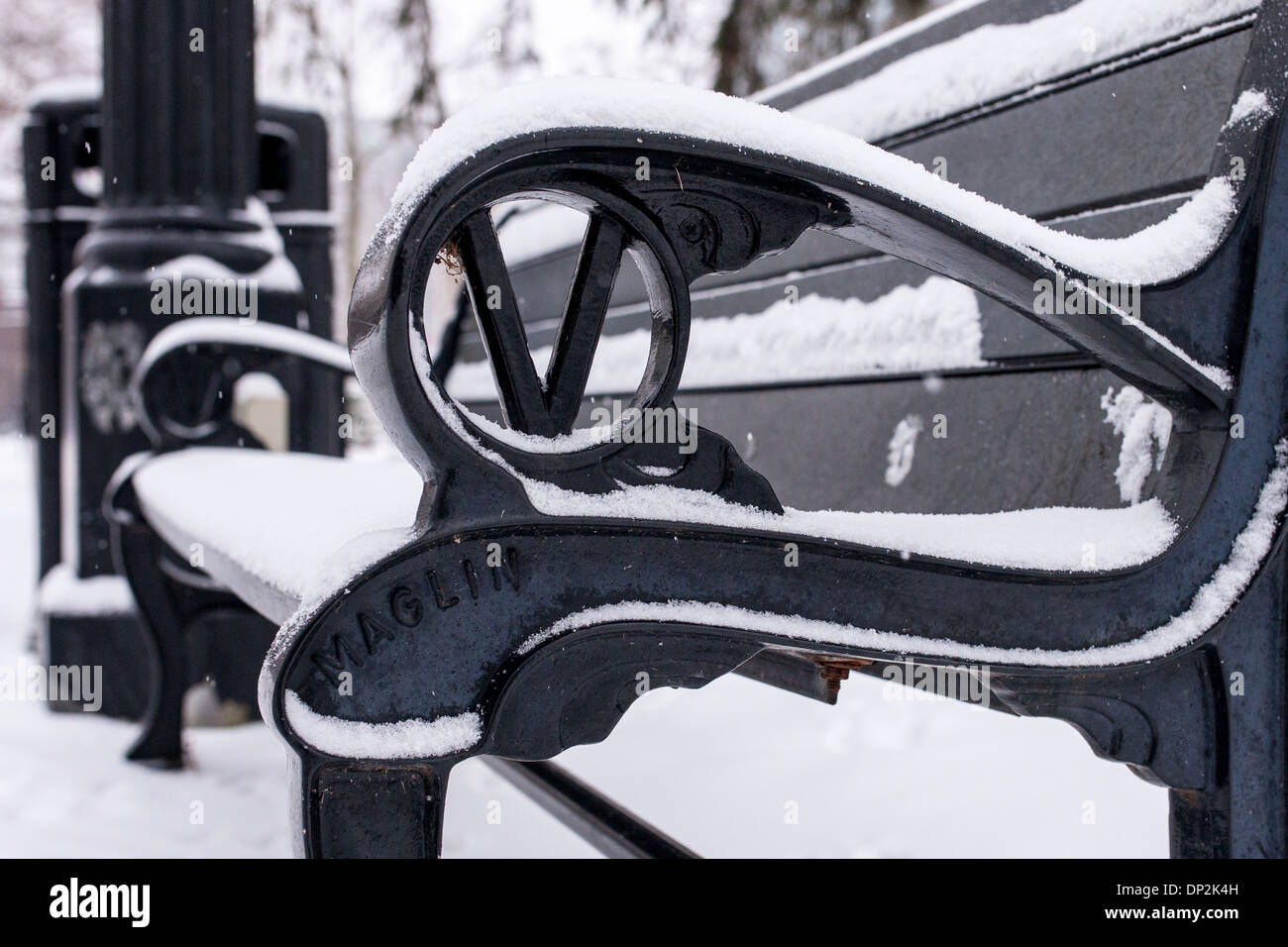 Recent snow fall covers trees, park benches and drinking fountains in Victoria Park. Stock Photo