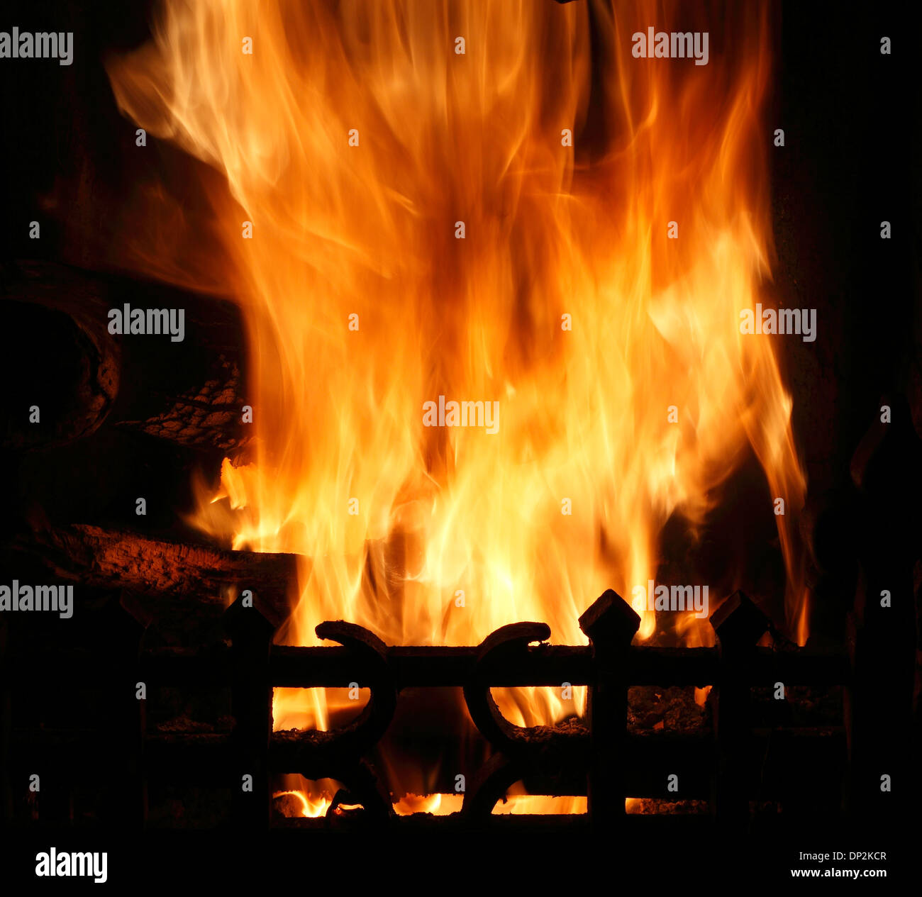 Fire in domestic hearth, heat flame flames heating fireside warmth fires grate burning wood coal home fires Stock Photo