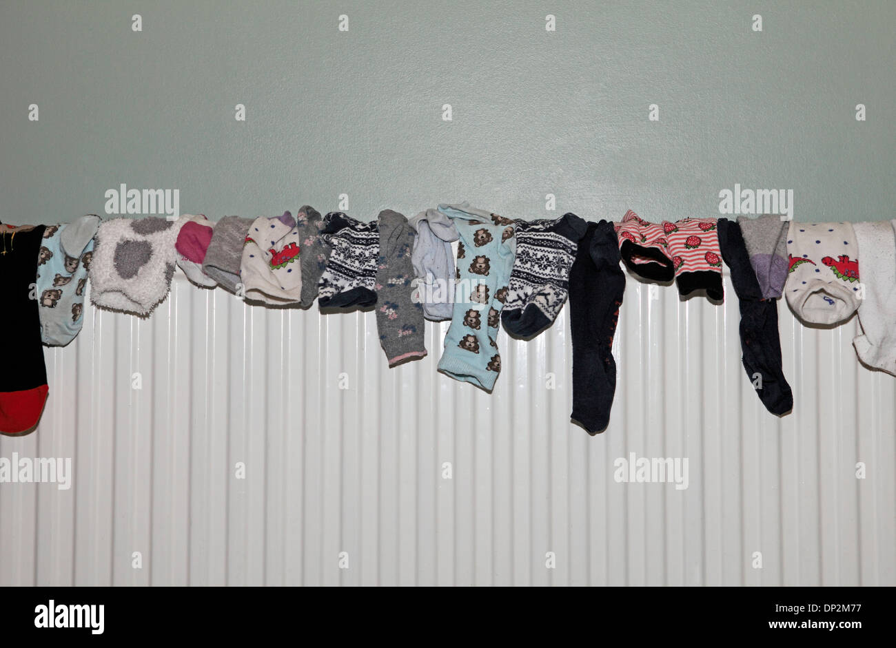 collection of socks drying on a radiator Stock Photo Alamy