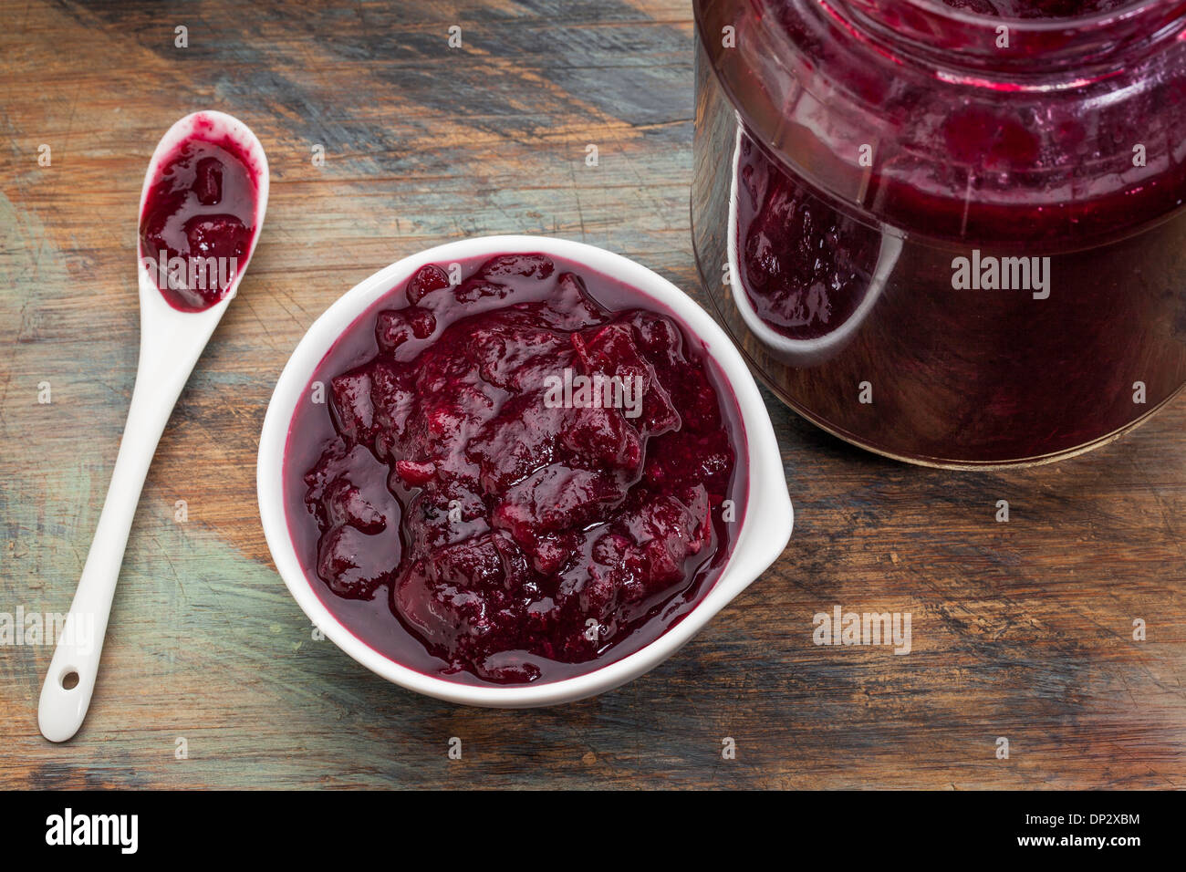 sugar free cranberry sauce with addition of blueberry, apples and honey - small bowl, jar and spoon Stock Photo