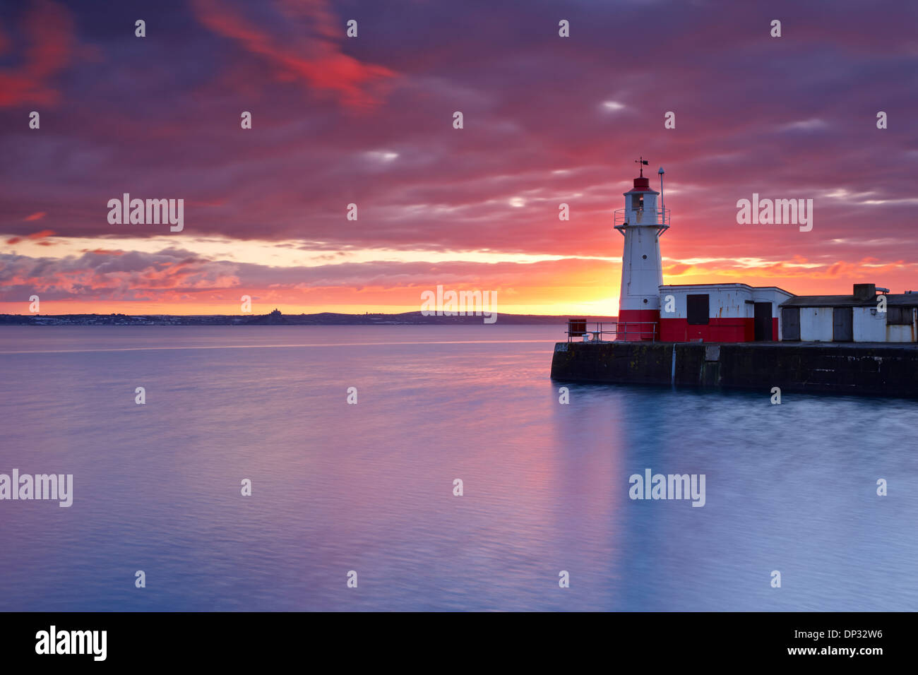 Sunrise over Newlyn Harbour Entrance and Mounts Bay Stock Photo