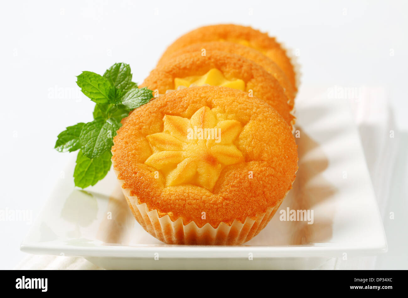 Custard filled muffins on long plate Stock Photo Alamy